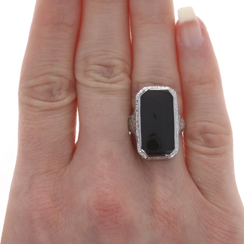 White Gold Onyx Art Deco Cocktail Solitaire Ring 18k Vintage Floral Filigree

Stone Information:
Natural Onyx
Color: Black

Additional information:
Material: Metal 18k White Gold
Style: Cocktail Solitaire
Features: Floral Filigree Design with