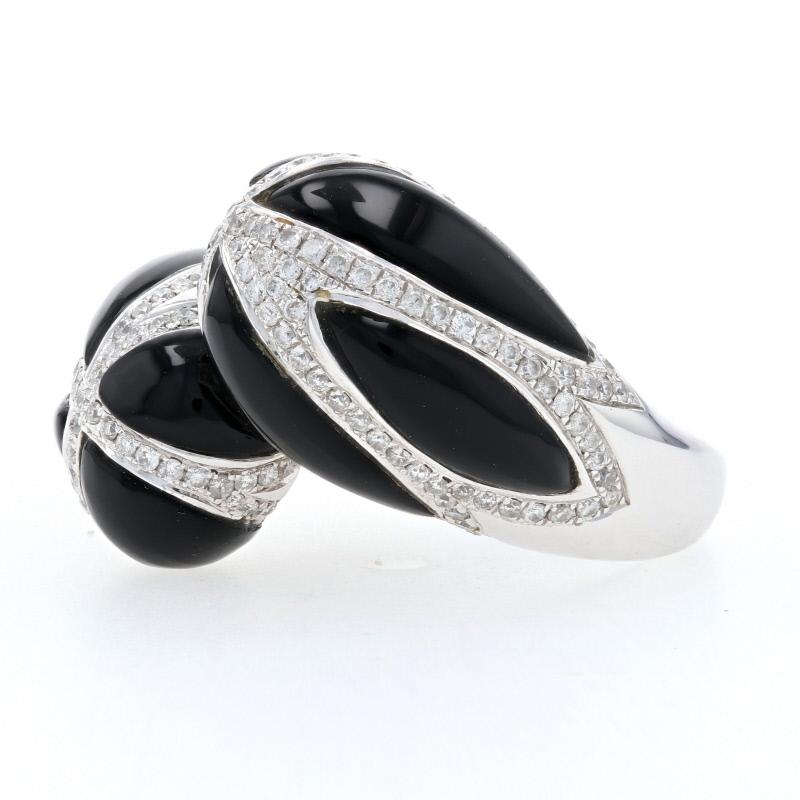 Black and white combos never seem to go out of style, and this gorgeous ring is the perfect accompaniment to your favorite pieces. Fashioned in high purity 18k white gold, this contemporary-designed ring features a bypass band adorned on the ends