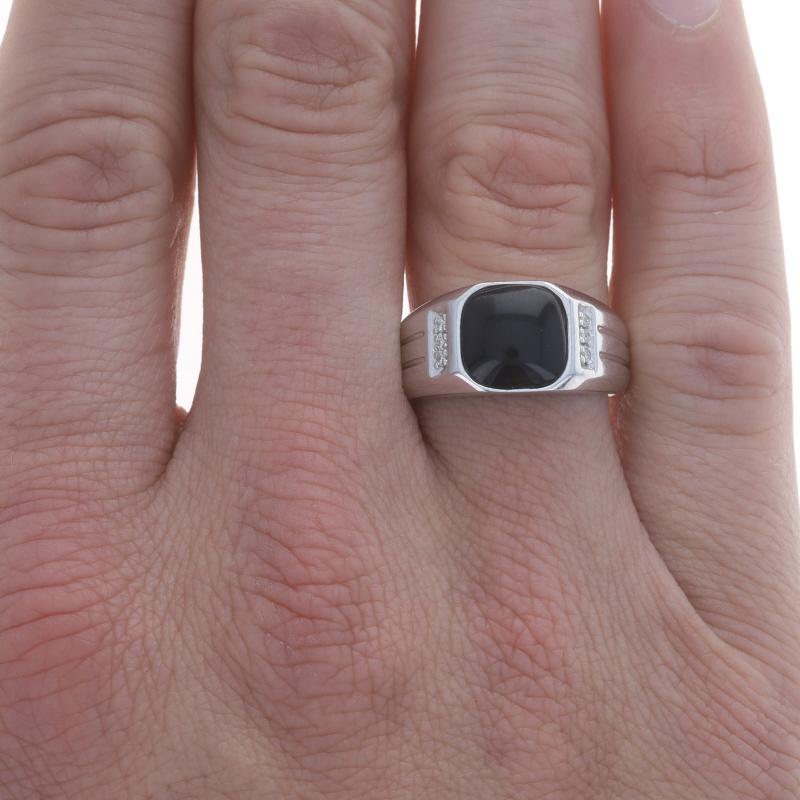 Size: 11 1/4
Sizing Fee: Up 1/2 a size for $30 or Down 2 sizes for $25

Metal Content: 10k White Gold

Stone Information

Natural Onyx
Cut: Cabochon Cushion
Color: Black

Natural Diamonds
Carat(s): .06ctw
Cut: Round Brilliant
Color: G - H
Clarity: