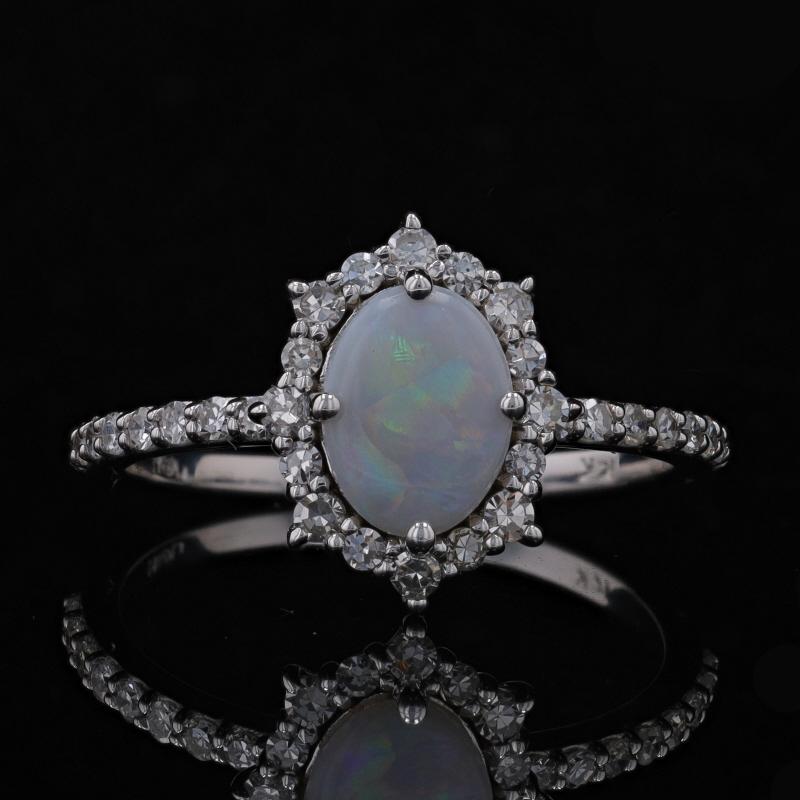 Size: 7 1/4
Sizing Fee: Up 2 sizes for $35

Metal Content: 14k White Gold

Stone Information
Natural Opal
Carat(s): .90ct
Cut: Oval Cabochon

Natural Diamonds
Carat(s): .38ctw
Cut: Single
Color: G - H
Clarity: SI2 - I1

Total Carats: 1.28ctw

Style: