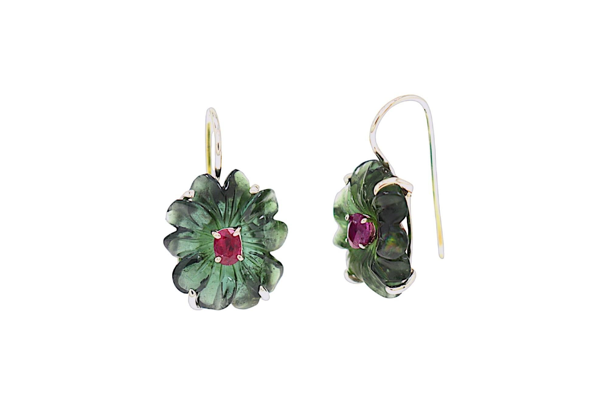 Elegant handmade earrings in 9k white gold, crafted in our jewelry workshop in Milan. The main stones are two hand-carved green tourmalines shaped like 10-petal flowers, with two natural oval-cut red rubies at the center. Both the rubies and