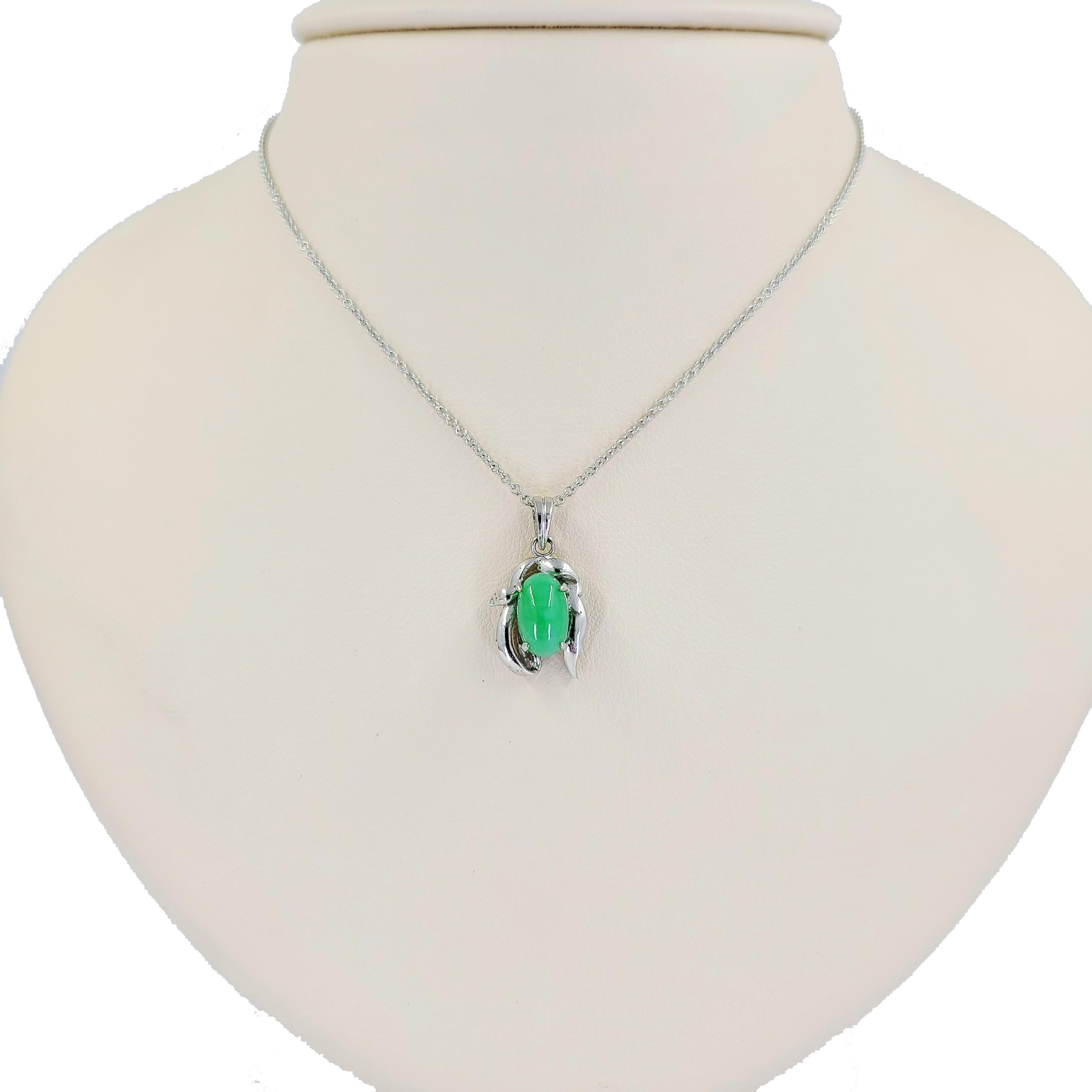 18 Karat White Gold Pendant Featuring An Oval Cabochon Cut Jade Surrounded By Freeform Gold. The Pendant Slides Freely On An 18 Karat White Gold 16 Inch Chain. Finished Weight Is 3.7 Grams.