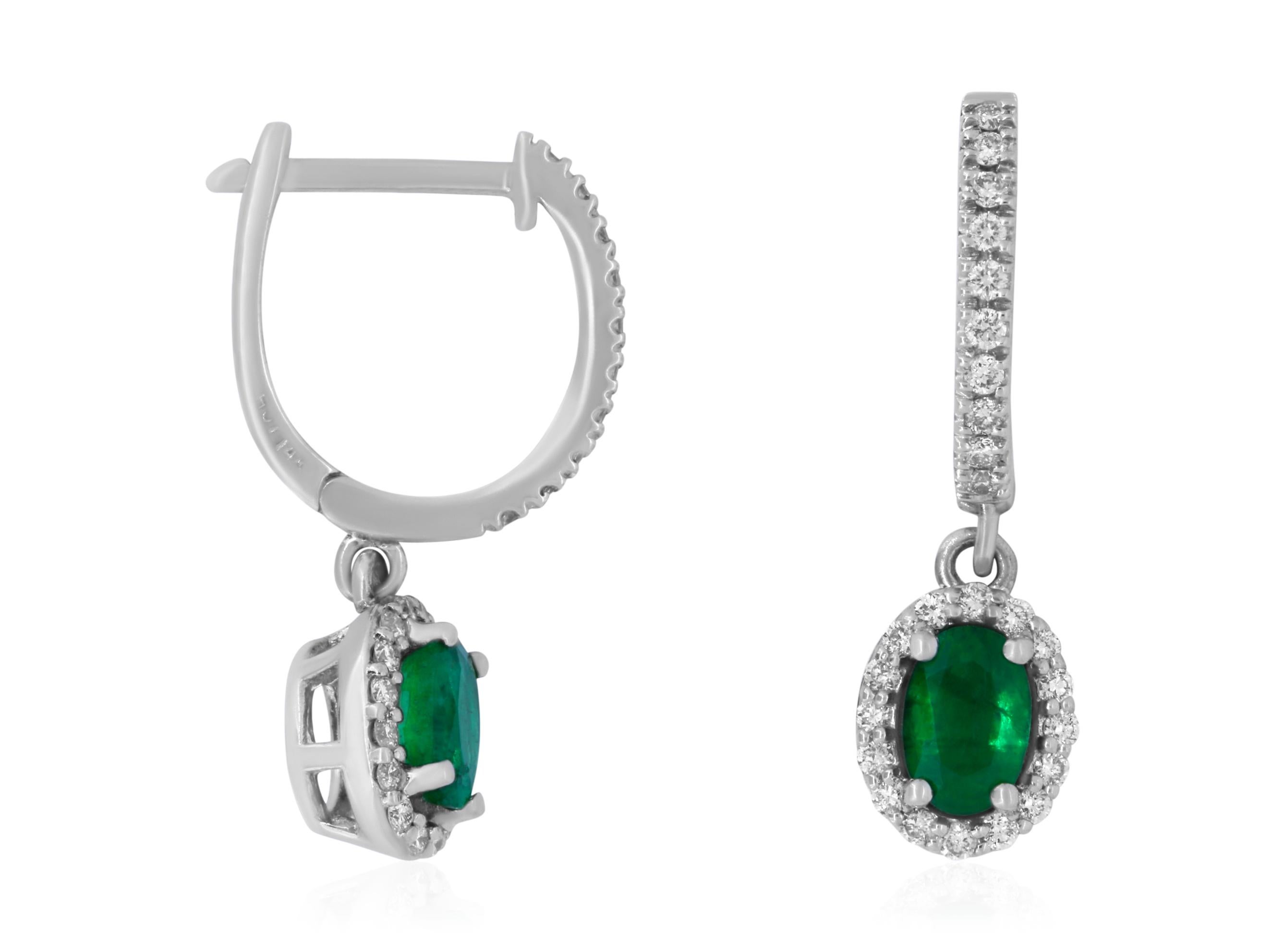 Material: 14k White Gold 
Stone Details: 2 Oval Shaped Emeralds at 0.96 Carats Total
Mounting Stone Details: 52 Brilliant Round White Diamonds at 0.41 Carats. Clarity: SI / Color: H-I

Fine one-of-a-kind craftsmanship meets incredible quality in