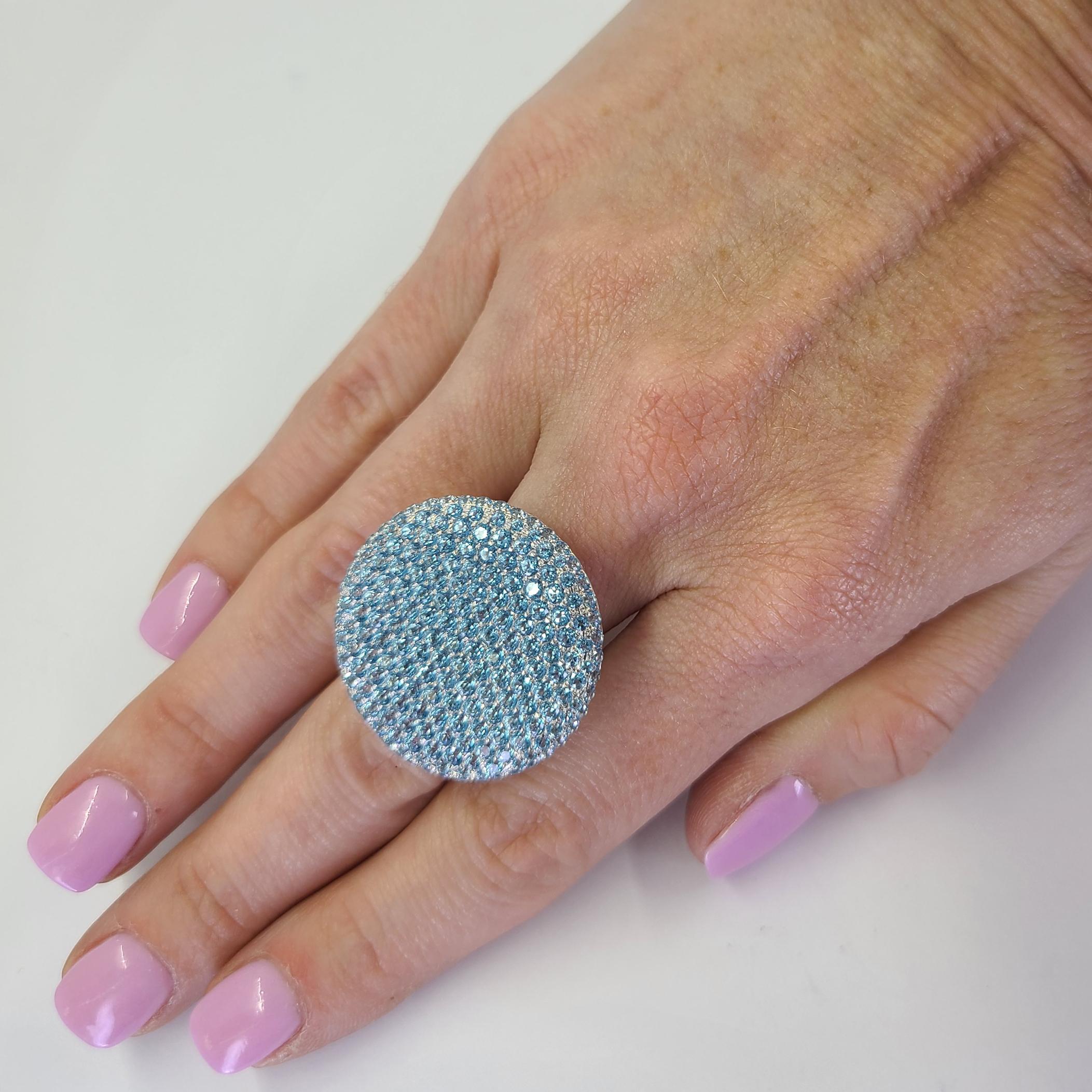 18 Karat White Gold Pave Disc Ring Featuring Approximately 5 Carats of Round Blue Topaz. Finger Size 9; Purchase Includes One Sizing Service. Finished Weight Is 14.2 Grams.