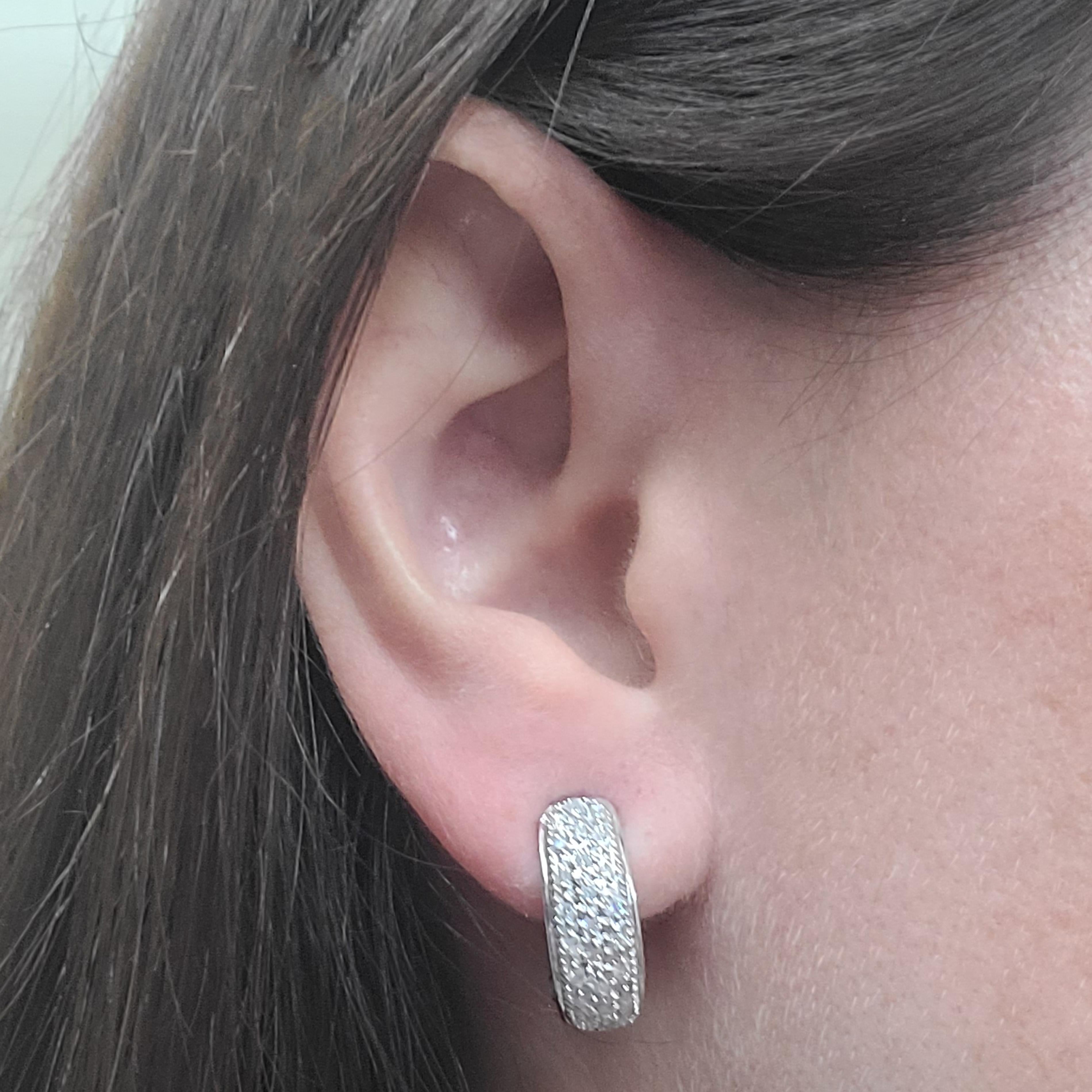 14 Karat White Gold Tapered Huggie Earrings Featuring 48 Pave-set Round Diamonds Of I1 Clarity & H Color Totaling 0.48 Carats. Finished Weight Is 3.6 Grams. Post With Secure Omega Clip Back.