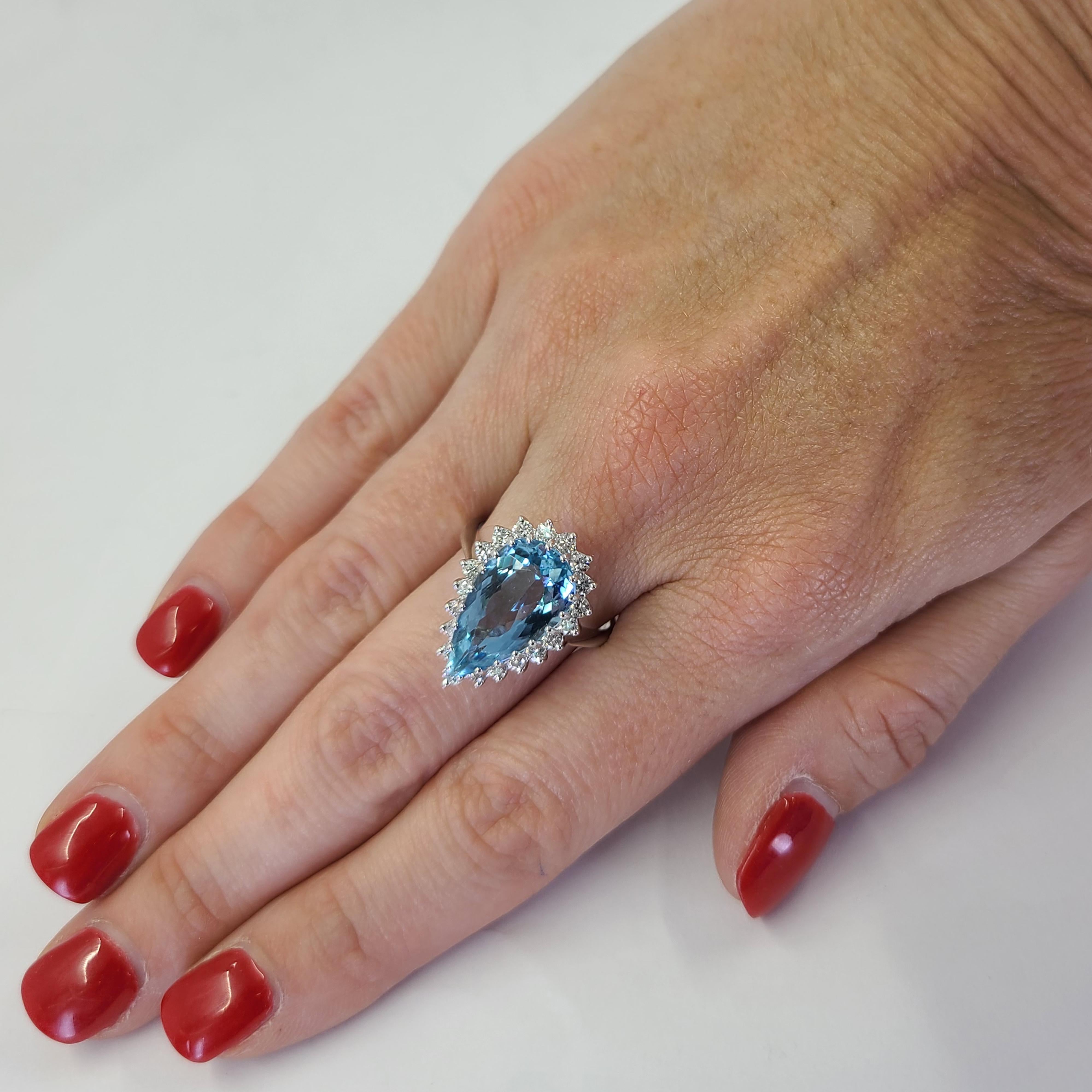 14 Karat White Gold Ring Featuring A 3.50 Carat Bright Blue Pear Cut Aquamarine Accented By A Halo of 20 Round Diamonds of VS Clarity and G Color Totaling 0.60 Carats. Finger Size 8; Purchase Includes One Sizing Service Prior to Shipping. Finished