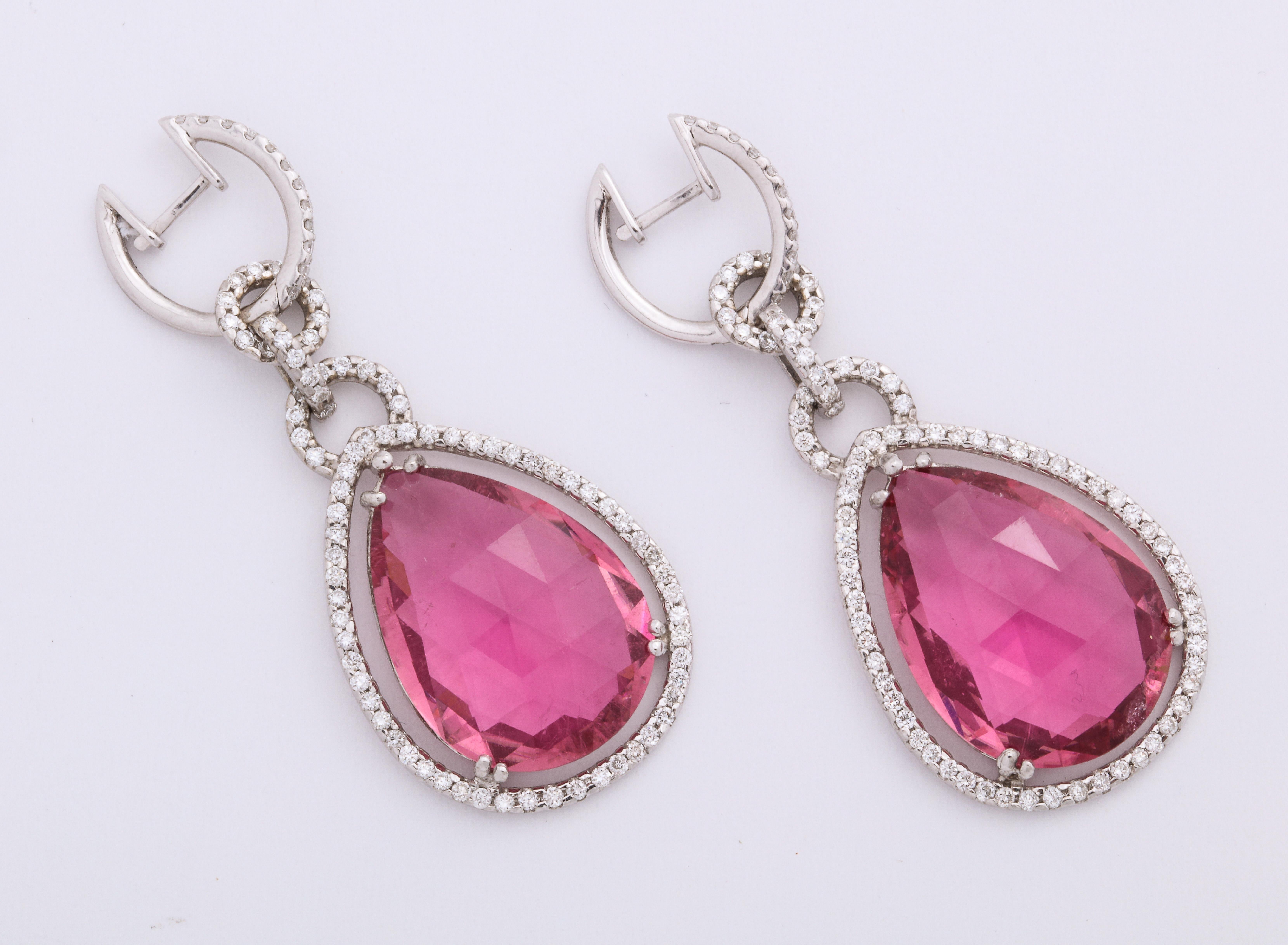 Fun, modern and bold 18K white gold hoop earrings decorated with colorless round brilliant-cut diamonds: 1.45 carats, suspending floating pear-shaped, briolette polish, rosy pink tourmaline pendants earrings.  For pierced ears only.
Dimensions: