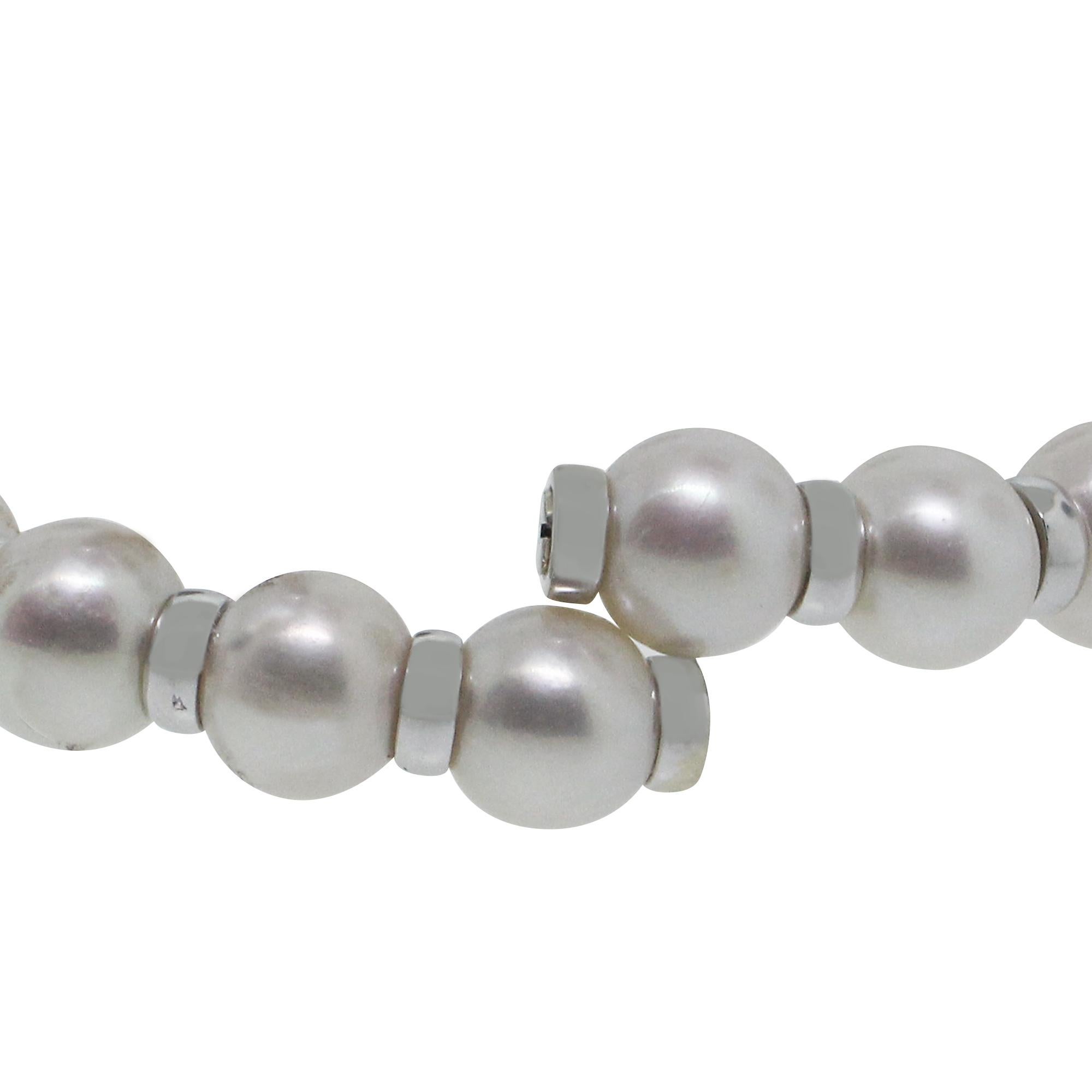 Material: 18k White Gold
Diamond Details: Approximately 0.50ctw round brilliant diamonds. Diamonds are G in color and SI in clarity.
Gemstone Details: Pearls are approximately 9.11mm in diameter
Measurements: 6″
Clasp: No clasp
Total Weight: 32.4g