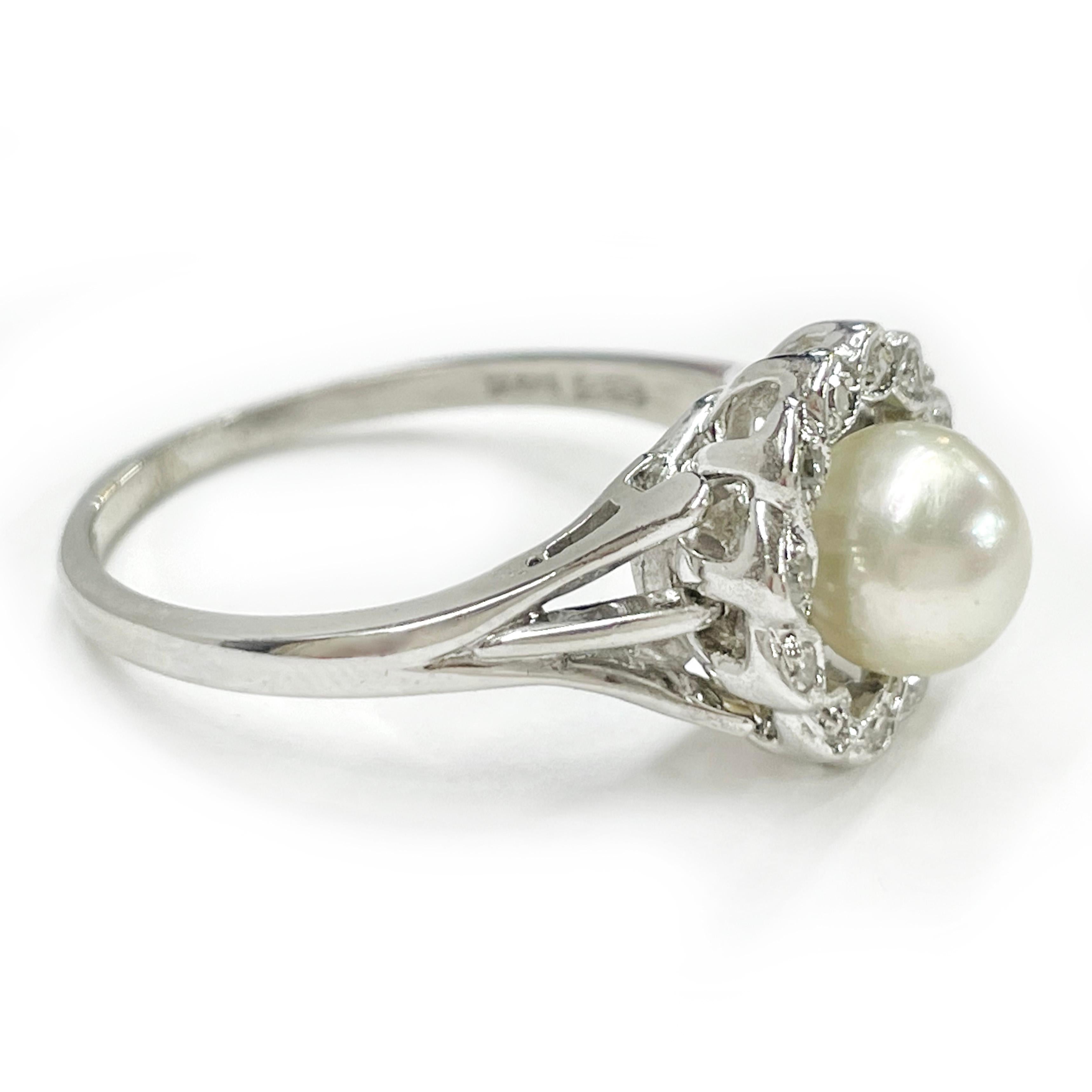 14 Karat White Gold Pearl Diamond Halo Ring. The ring features a center pearl and a halo of twelve round bead-set melee diamonds. The 7mm cultured white pearl has good luster. Around the diamonds is milgrain detail. Stamped on the inside of the band