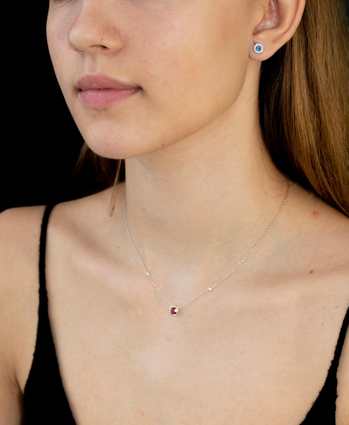 14 karat white gold necklace pendant with one ruby bezel set and two bezel-set brilliant cut diamond
Sixteen inch long
Diamond total weight 0.10 carat
Center ruby weight 0.85 carat
Thin cable chain necklace with spring lock: a lock that fastens with