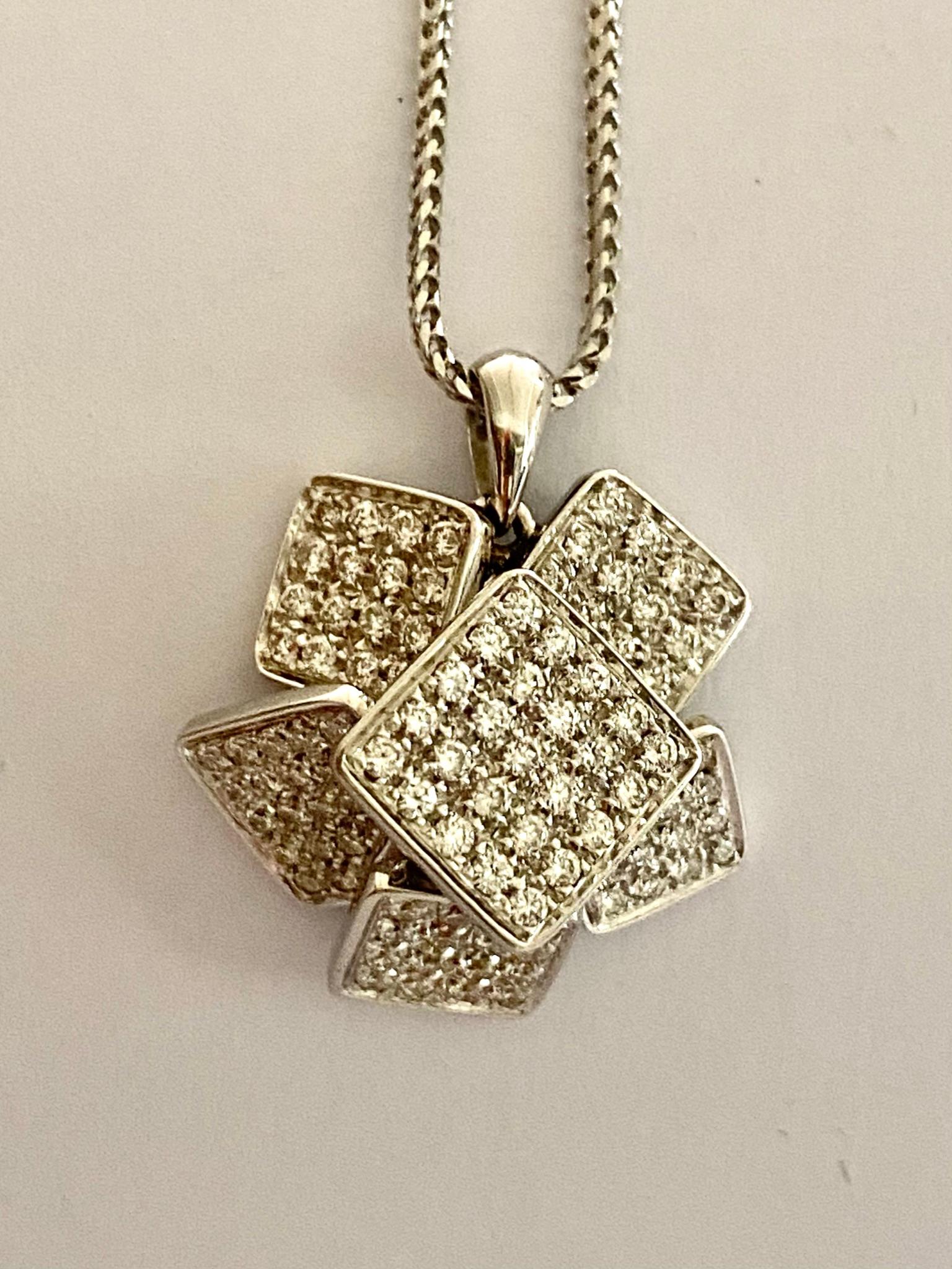 One (1) 18 Karat white Gold Pendant with Chain
stamped 750
107 (one hunderd and seven) round brilliant cut natural diamonds = 0.090 ct.  
Clarity grade; VS  Color Grade: F-G  (Top Wesselton)
Lenght of the cahin 42 cm. (including lock)
Total Weight: