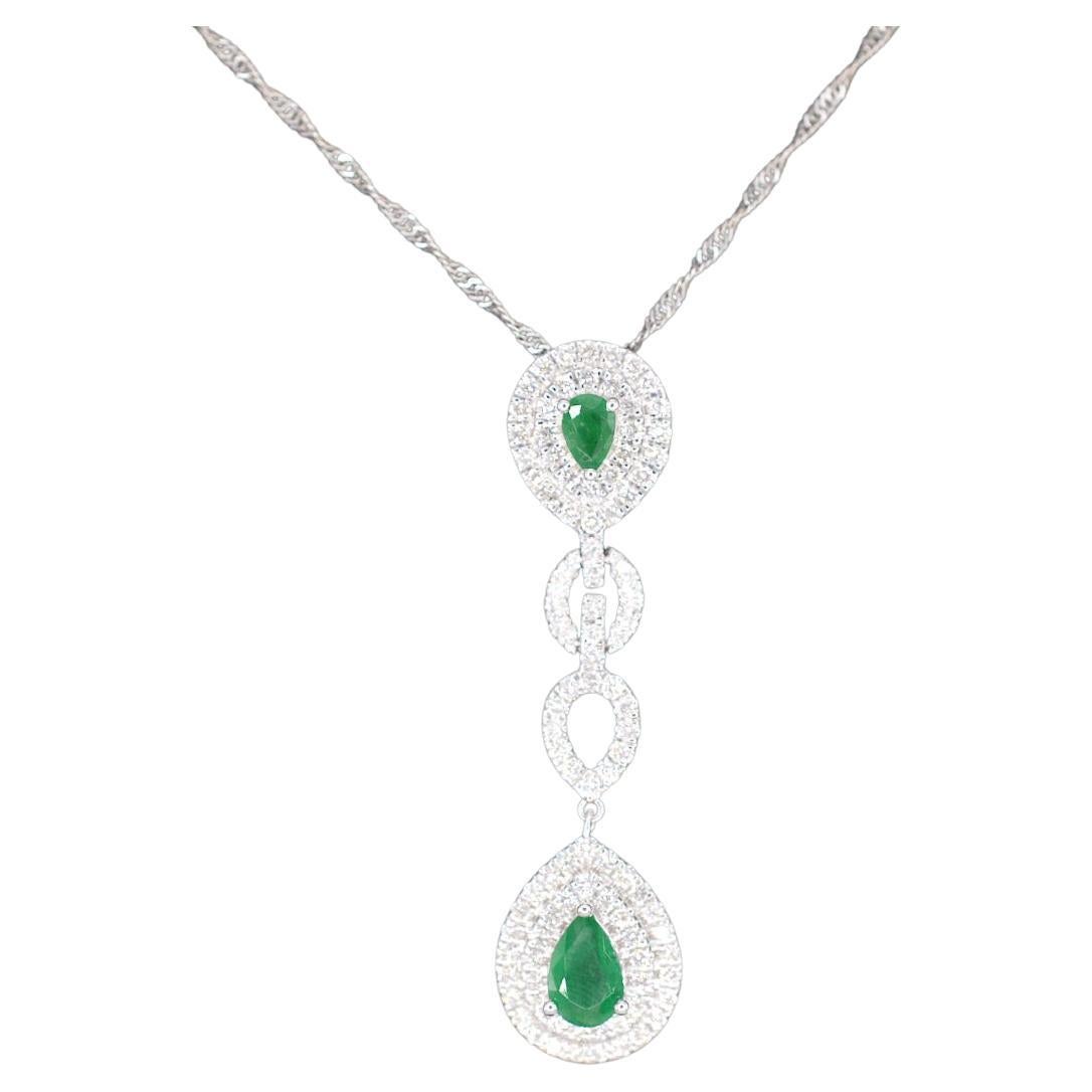 White Gold Pendant Set with Diamonds and Emeralds For Sale