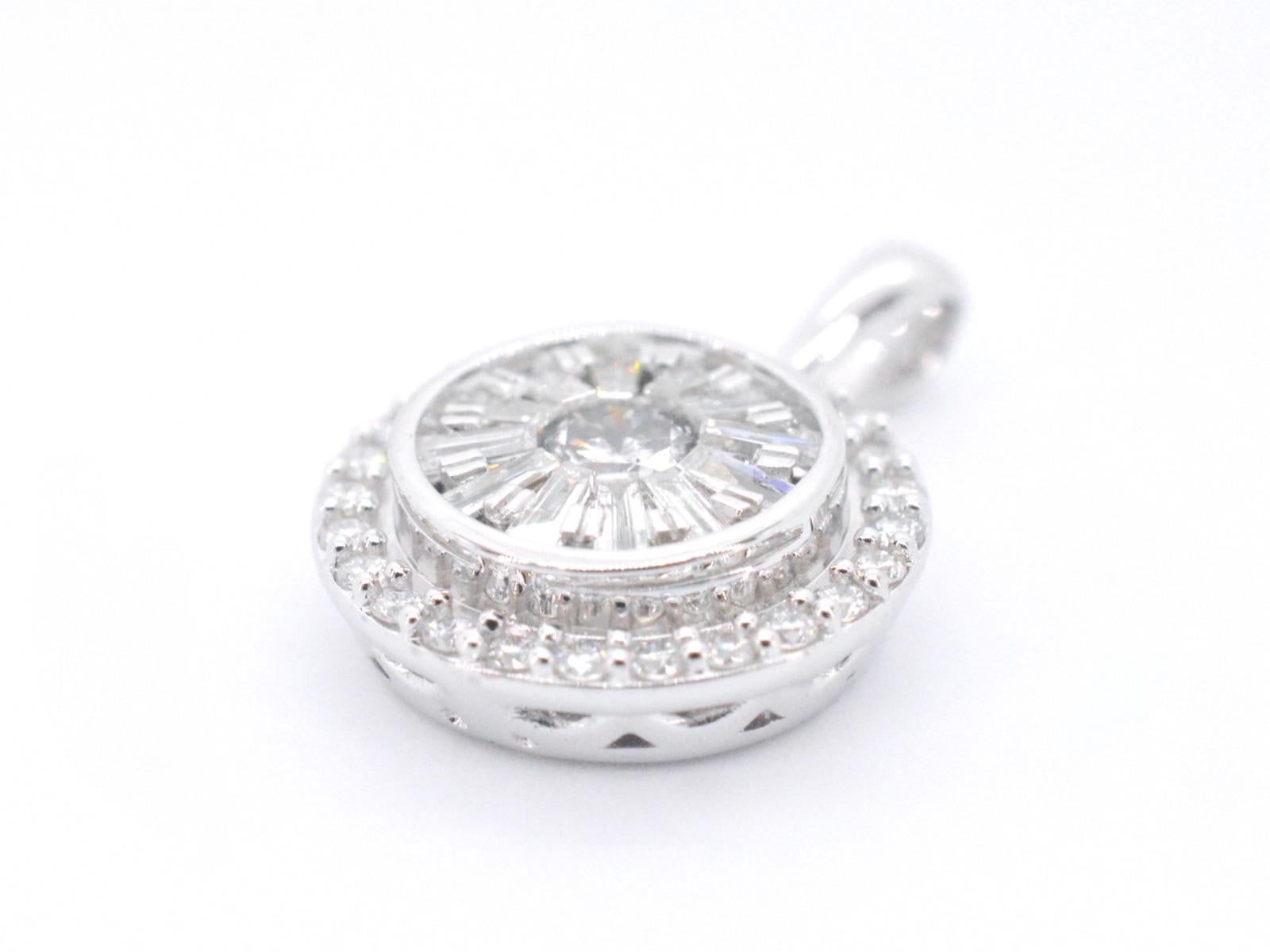 This stunning white gold pendant features a total of 0.75 carats of brilliant and baguette cut diamonds arranged in a classic round design. The diamonds are expertly set in a pave setting, creating a beautiful and seamless surface of sparkling gems.