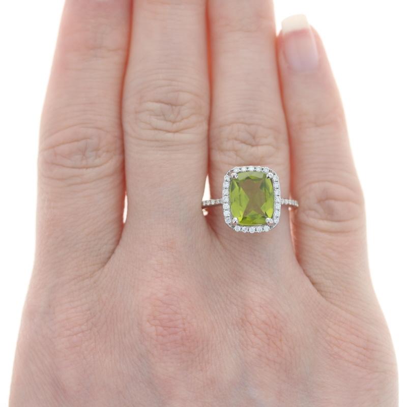 Size: 7
Sizing Fee: Up 1 size for $35

Metal Content: 14k White Gold

Stone Information

Natural Peridot
Carat(s): 3.46ct
Cut: Cushion
Color: Green
Stone Note: (weighed)

Natural Diamonds
Carat(s): .38ct
Cut: Round Brilliant
Color: H - I
Clarity:
