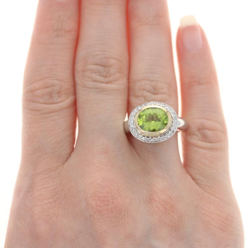 Size: 6 3/4 
Sizing Fee: Up 1 size for $50

Metal Content: 14k Yellow Gold & 14k White Gold

Stone Information

Natural Peridot
Carat(s): 2.80ct
Cut: Oval
Color: Green

Natural Diamonds
Carat(s): .30ctw
Cut: Round Brilliant
Color: F - G
Clarity: VS2