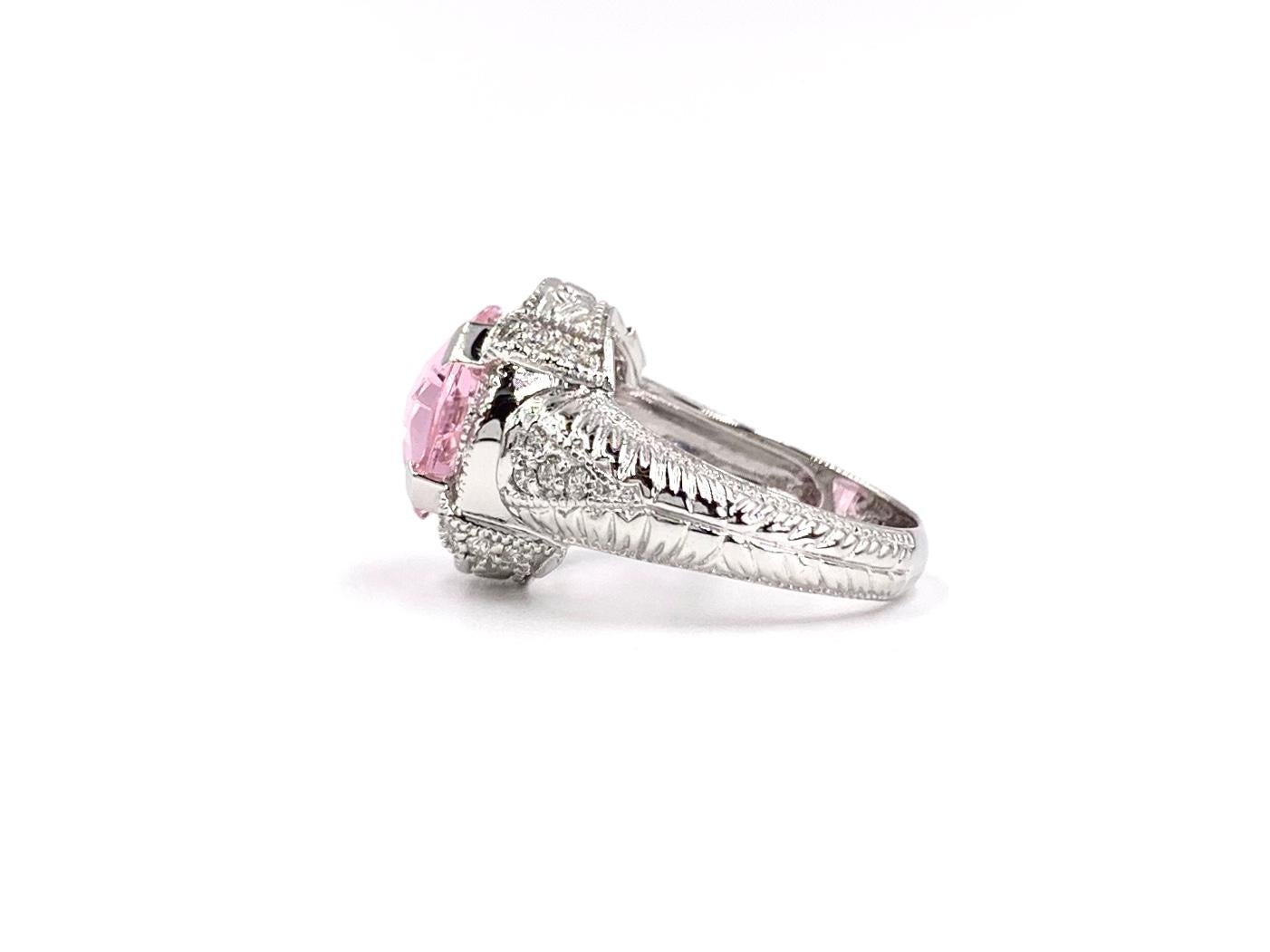 Beautiful and bright, this 14 karat white gold fashion ring features a checkerboard faceted cushion cut pink quartz and .50 carat of white round brilliant diamonds. Diamond quality is approximately G color, SI1 clarity. Diamond of ring measures 15mm