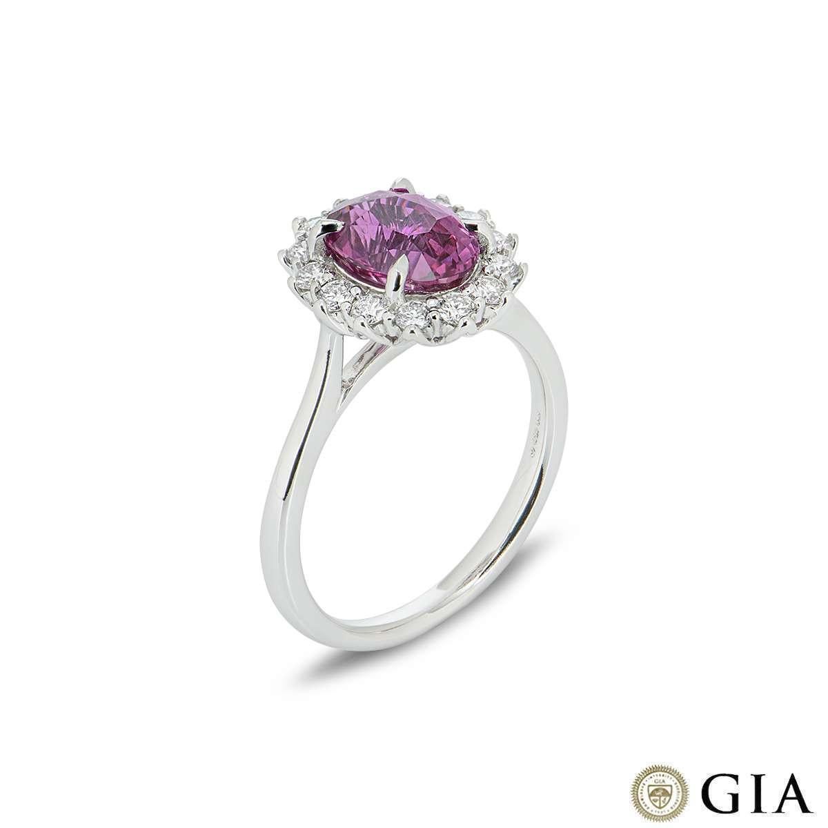 A stunning pink sapphire and diamond ring in 18k white gold. The oval cut pink sapphire weighs 2.58ct and displays a bright even pink colour, with no indications of heating. Surrounding the sapphire are 14 round brilliant cut diamonds totalling