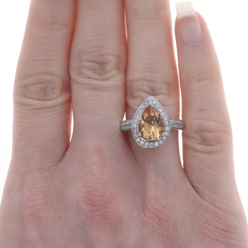 Size: 6 3/4
Sizing Fee: Up 2 sizes for $40 or Down 1 size for $30

Metal Content: 14k White Gold

Stone Information

Natural Precious Topaz
Treatment: Routinely Enhanced
Carat(s): 2.42ct
Cut: Pear
Color: Light Orange

Natural Diamonds
Carat(s):