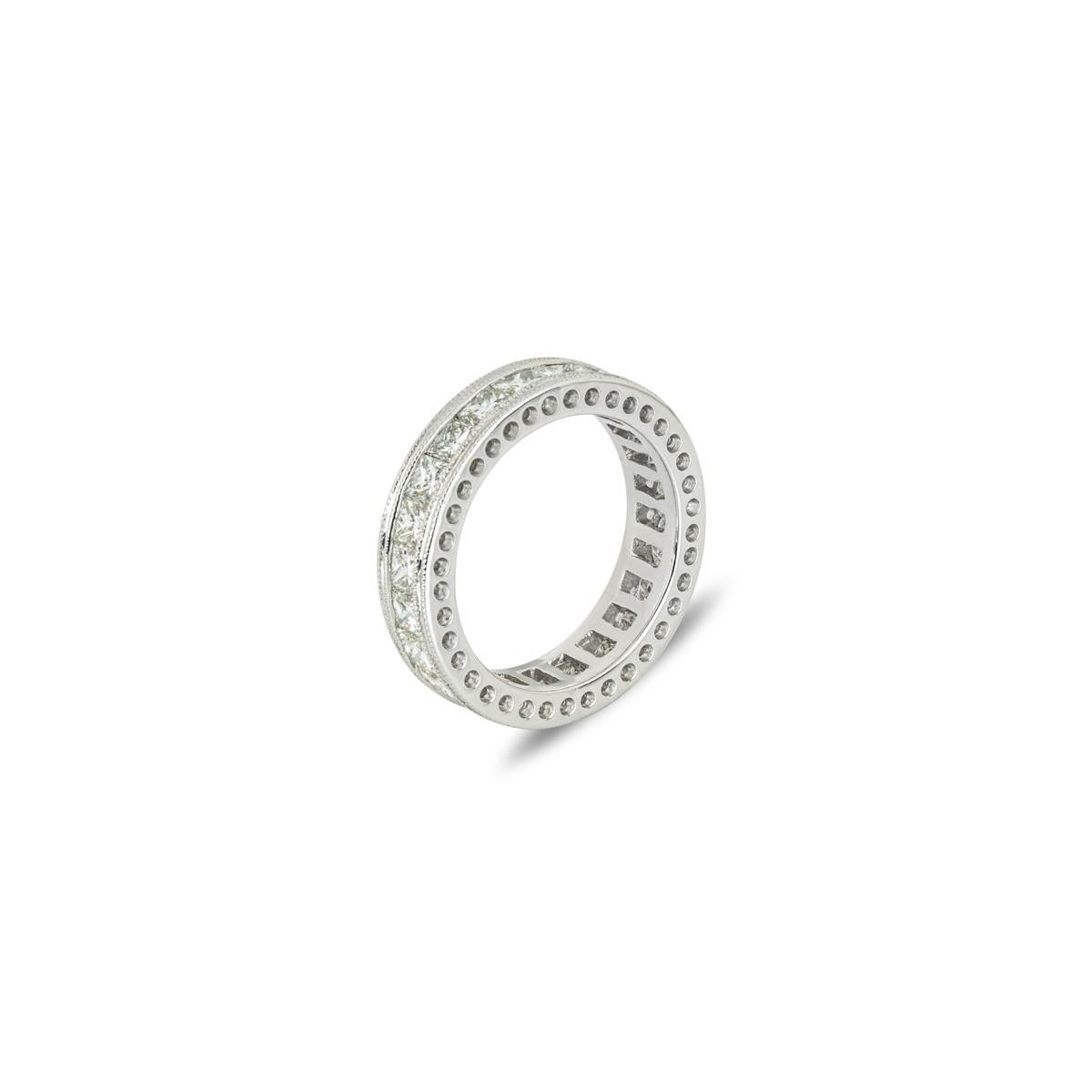 A beautiful 18k white gold diamond full eternity ring. The ring is channel set within a milgrain border, with 22 princess cut diamonds with an approximate total weight of 2.00ct, G-H colour and VS clarity. The 5mm wide band is a UK size L½/ US size