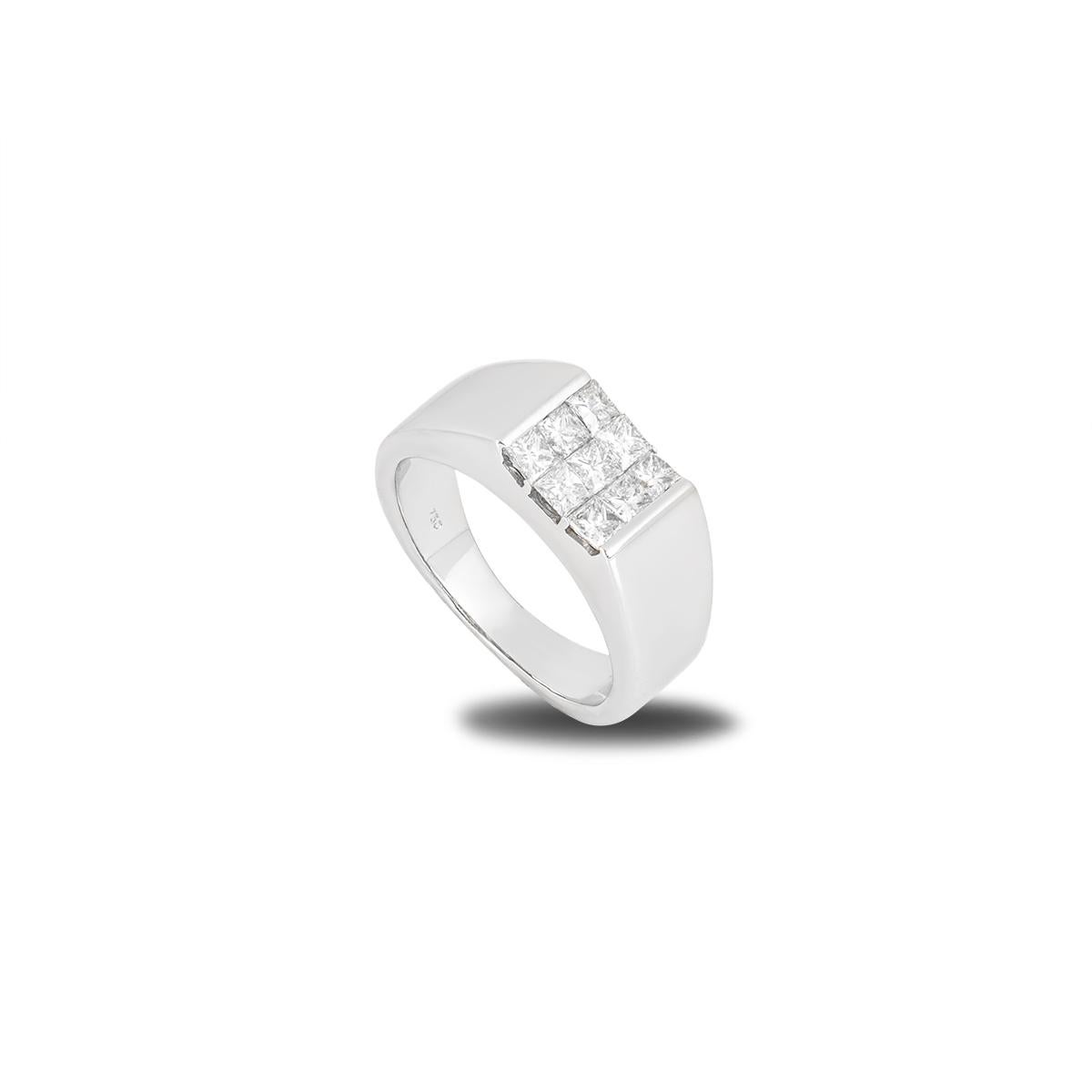 An 18k white gold diamond signet ring. The ring comprises of 9 princess cut diamonds set across 3 rows in a tension setting, with a total diamond weight of approximately 0.70ct. Measuring at 8mm the band tapers down to 4mm, it is a size UK O, US 7