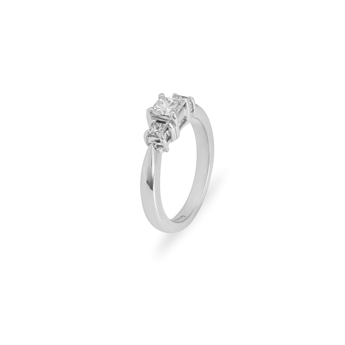 A beautiful 18k white gold diamond three stone ring. The ring is set to the centre with a princess cut diamond weighing 0.45ct, I colour and VS2 clarity. Further complementing the centre diamond are two princess cut diamonds set to either side