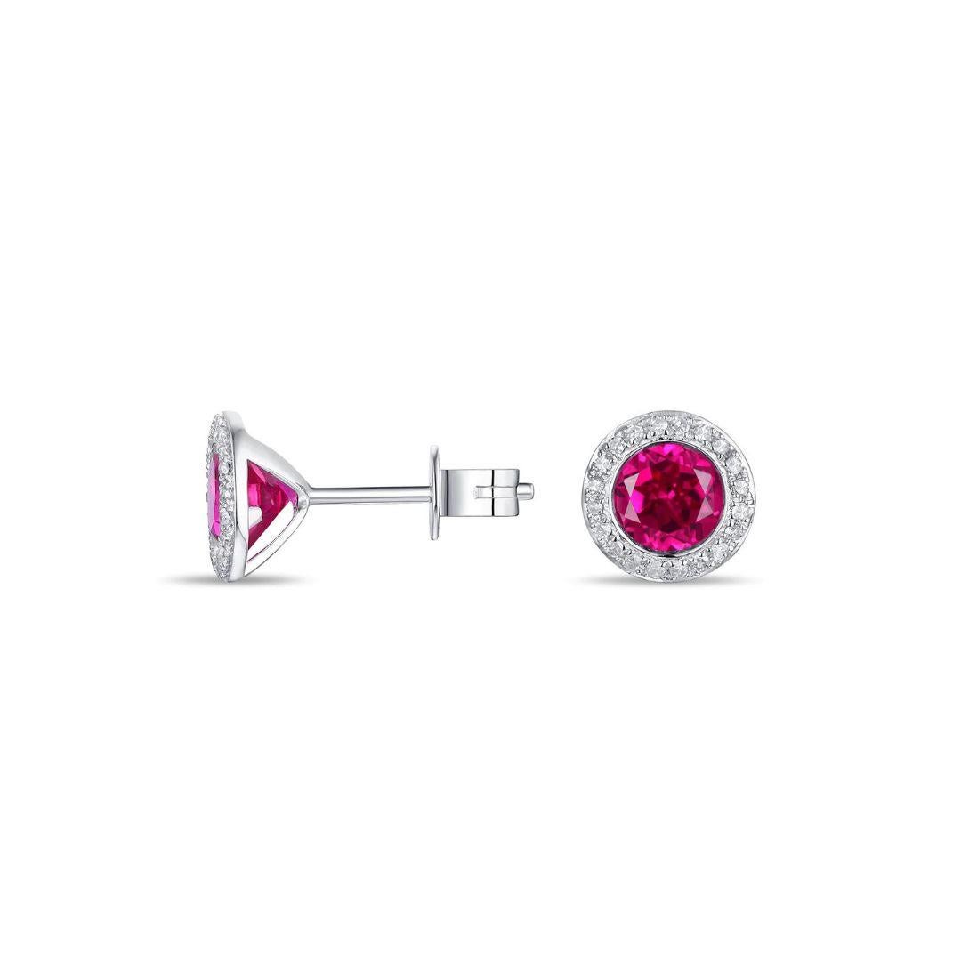 Classic diamonds and red corundum stud earrings in soft 14k white gold. Elegant look with versatile use, these earrings make a great gift for any special occasion. Earrings contain forty round white diamonds, H-I color, SI clarity, 0.11 ctw and two