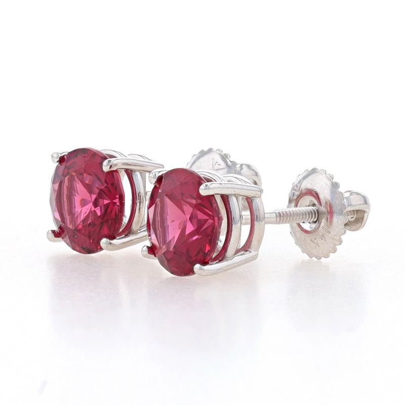 Metal Content: 14k White Gold

Stone Information
Natural Rhodolite Garnets
Carat(s): 3.05ctw (weighed)
Cut: Round
Color: Purplish Red

Total Carats: 3.05ctw

Style: Stud
Fastening Type: Pierced Screw-On Closures

Measurements
Diameter: 9/32