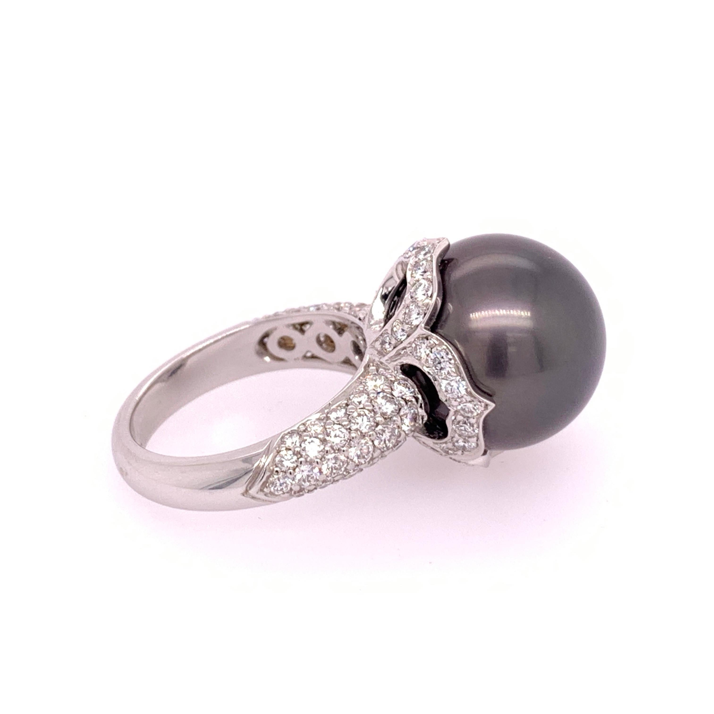 An 18k white gold ring (size 6.5)

Set with a 15mm Black Tahitian Pearl and 92 Natural colorless Round Brilliant Diamonds (F in color and VS in clarity) weighing 2.20 carats.