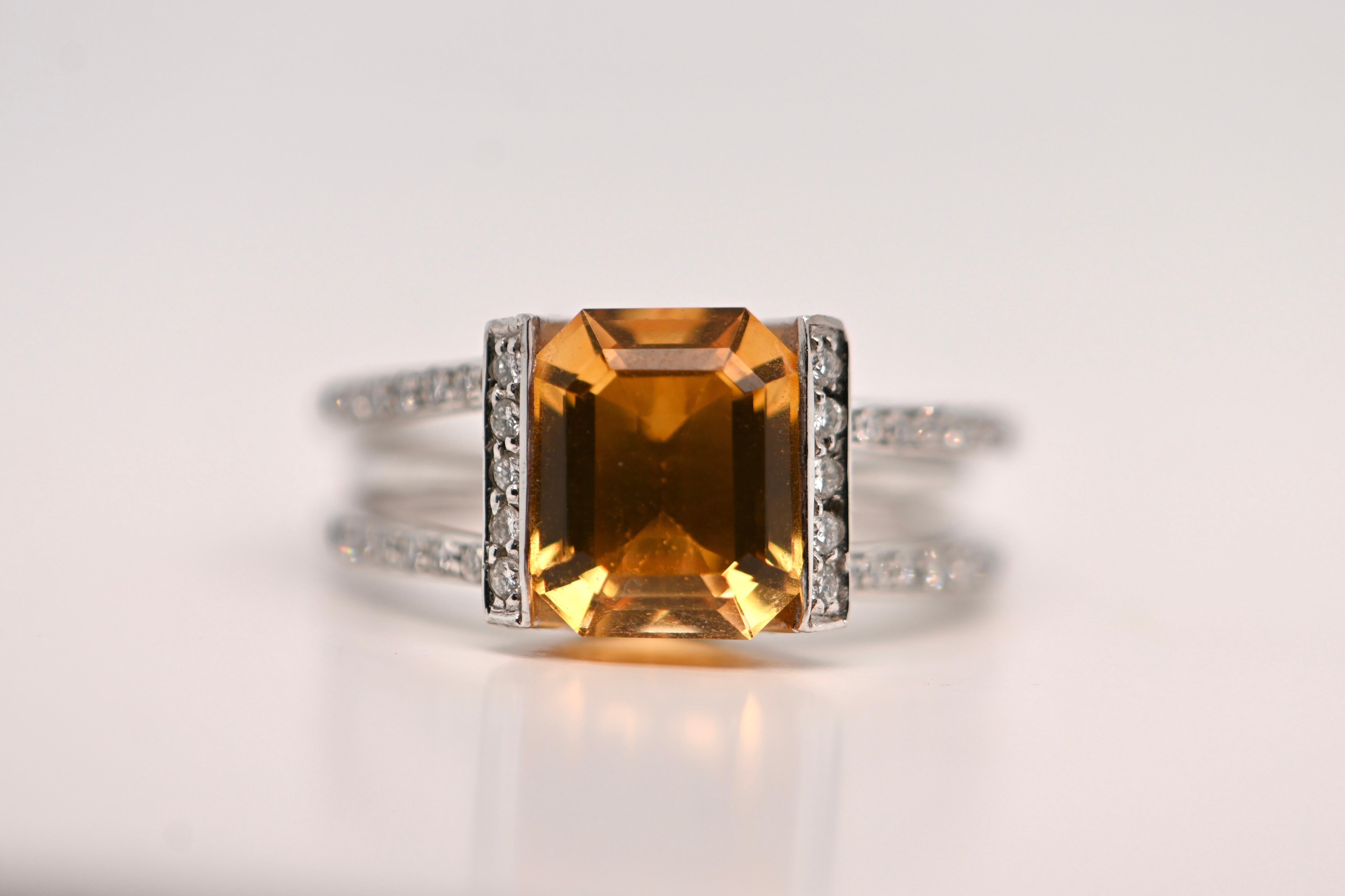 Immerse yourself in elegance with this stunning 18-carat white gold ring, featuring a breathtaking emerald-cut citrine weighing 3.800 carats at its center. Surrounding the citrine are 52 brilliant-cut diamonds totaling 0.420 carats, each boasting a