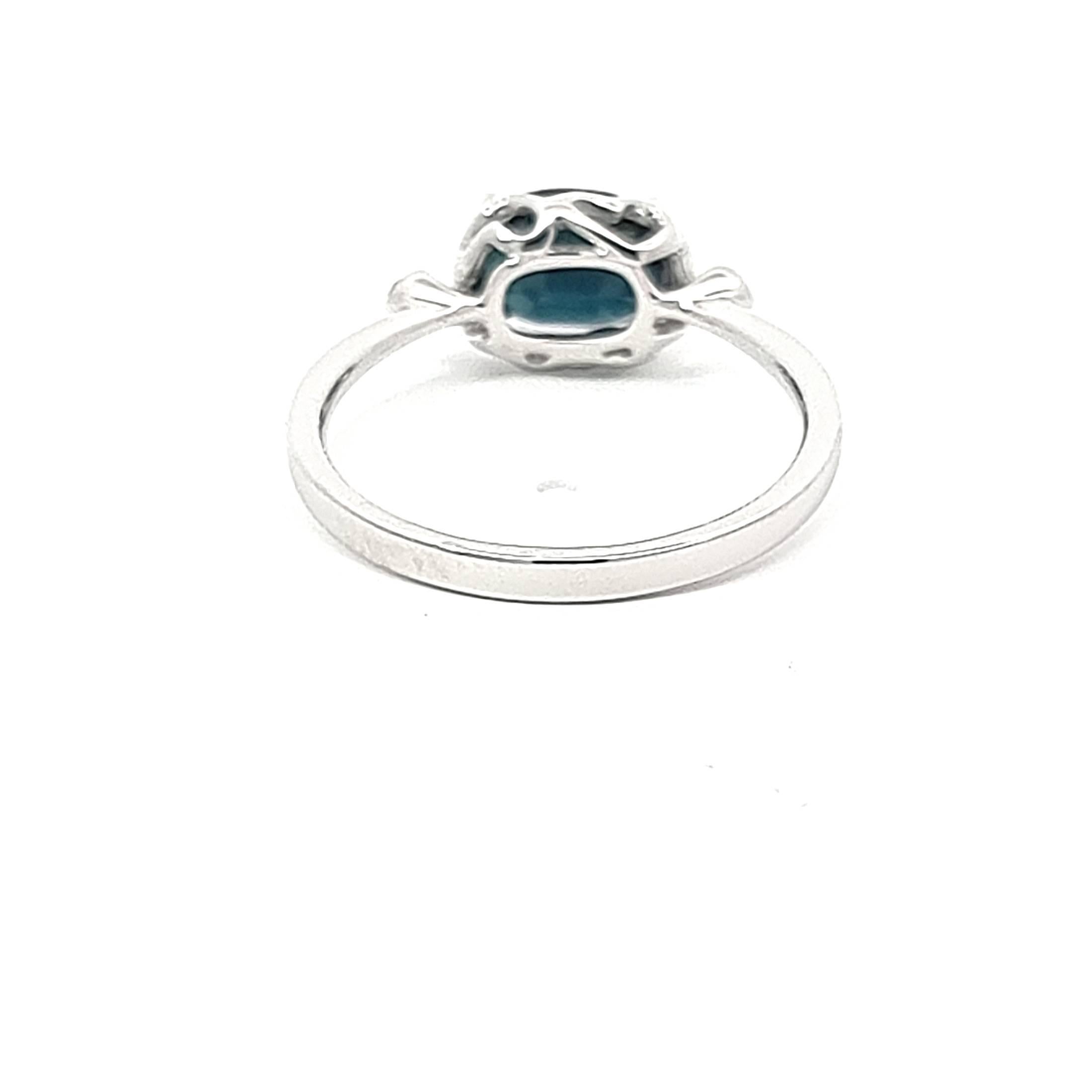 Oval Cut White Gold Ring Featuring Dark Blue Oval Sapphire and White Diamonds For Sale