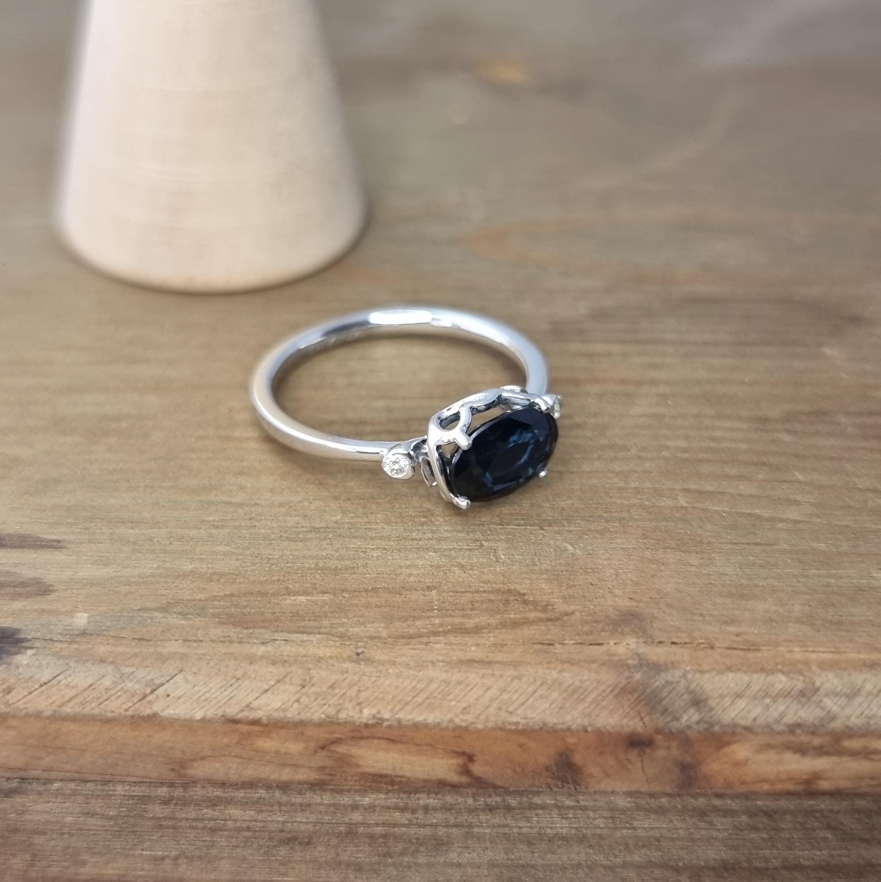 White Gold Ring Featuring Dark Blue Oval Sapphire and White Diamonds For Sale 1