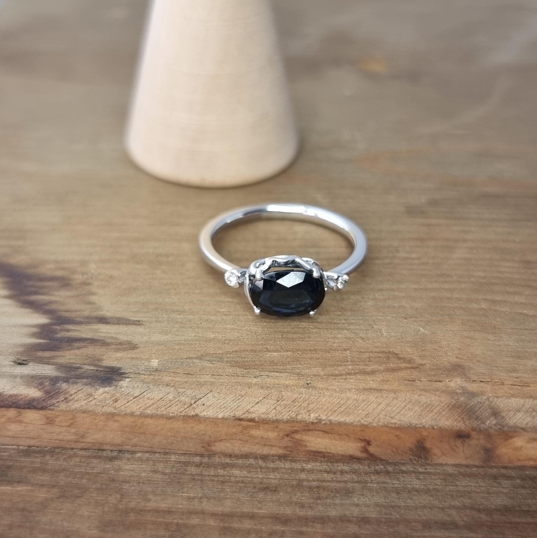 White Gold Ring Featuring Dark Blue Oval Sapphire and White Diamonds For Sale 2