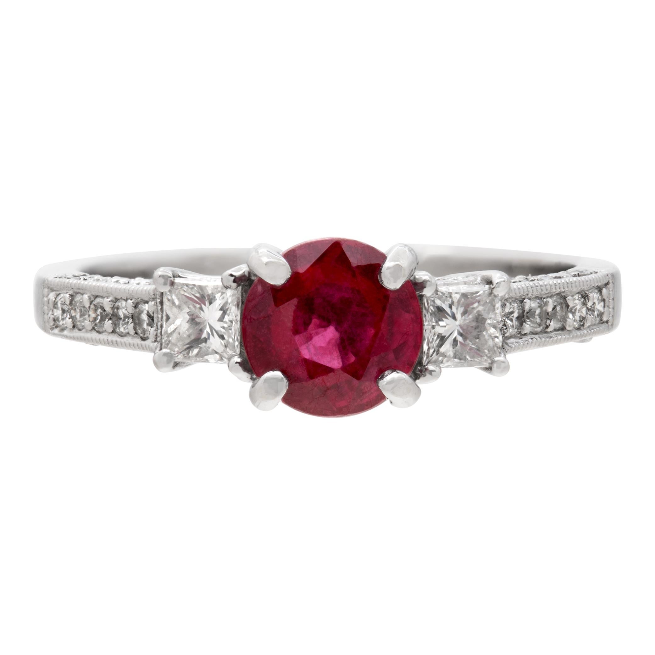 18k white gold ring with approx 0.80 ct princess cut center ruby with approx 0.30 cts of diamond accents. Size 7.This Ruby ring is currently size 7 and some items can be sized up or down, please ask! It weighs 2.4 pennyweights and is 18k White Gold.
