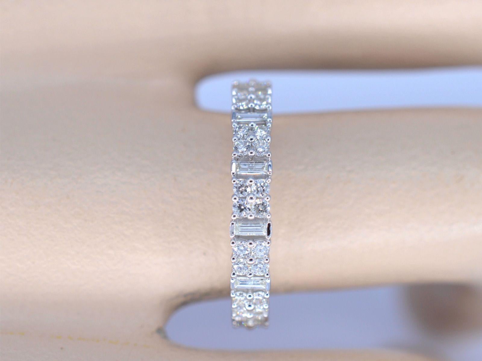 Allow us to introduce you to an exquisite white gold ring, adorned with a stunning row of diamonds. This ring features a breathtaking combination of brilliant and baguette cut diamonds, each one set flawlessly to create a truly mesmerizing design.