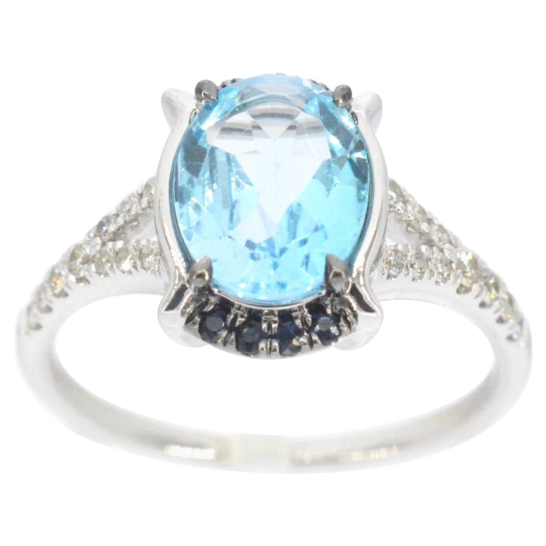 Bague en or blanc avec diamants et belle topaze avec saphir