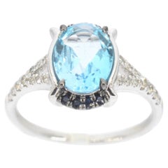 Anello in oro bianco con diamanti e splendido topazio con zaffiro
