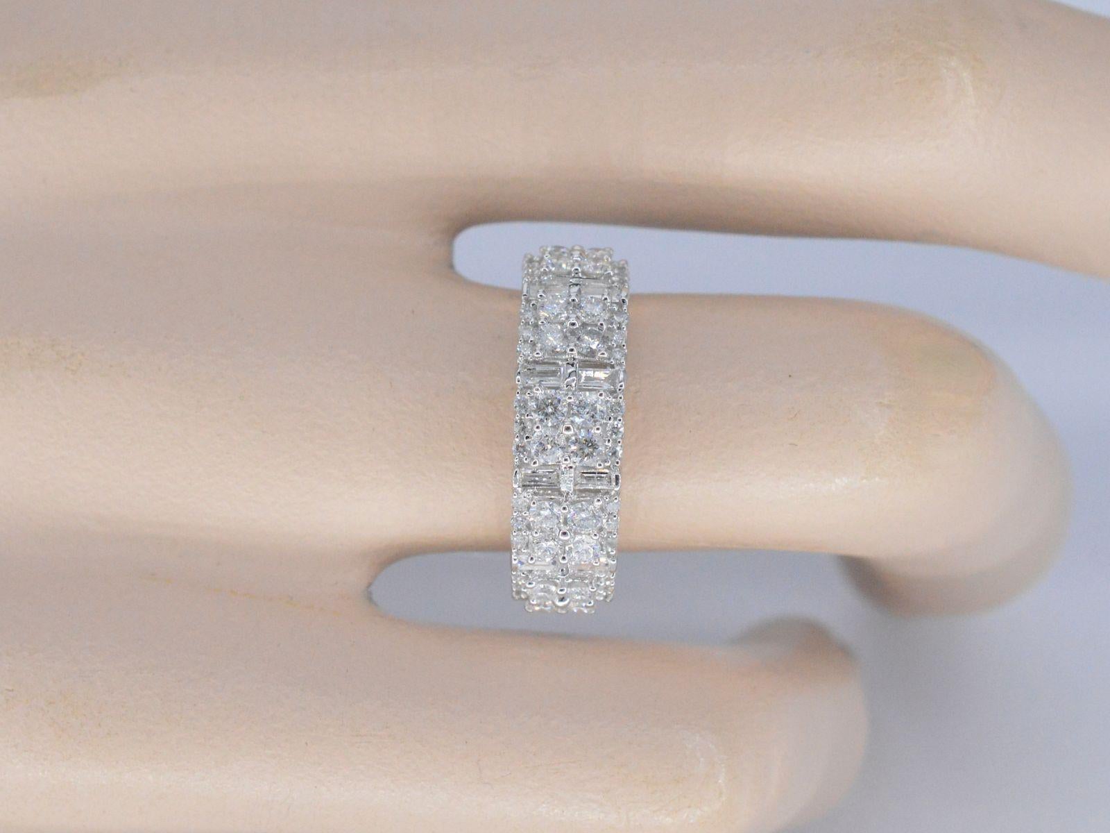 This stunning white gold ring features a combination of 1.10 carats of brilliant and baguette cut diamonds arranged in a breathtaking pave setting. The diamonds create a beautiful and seamless surface of dazzling gems that sparkle brilliantly in the