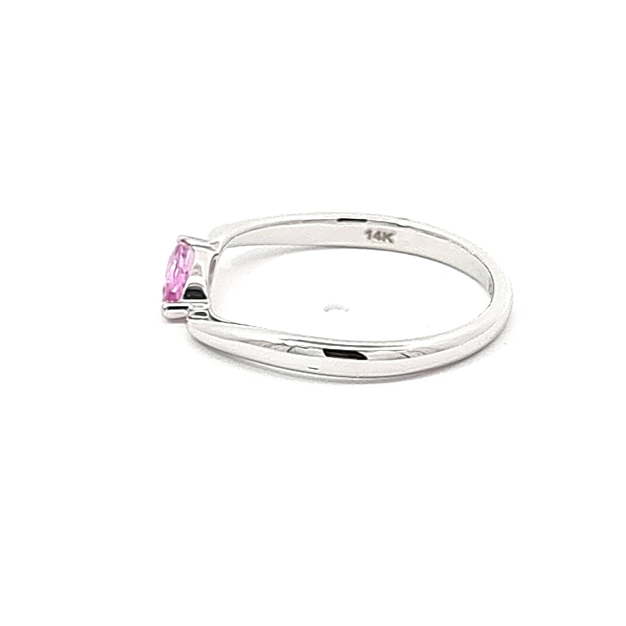 Step into a world of refined elegance with our 14K White Gold Ring, a mesmerizing blend of sophistication and warmth. This exquisite piece features a single marquise-cut pink sapphire, cradled in a delicate twist setting that adds a touch of grace