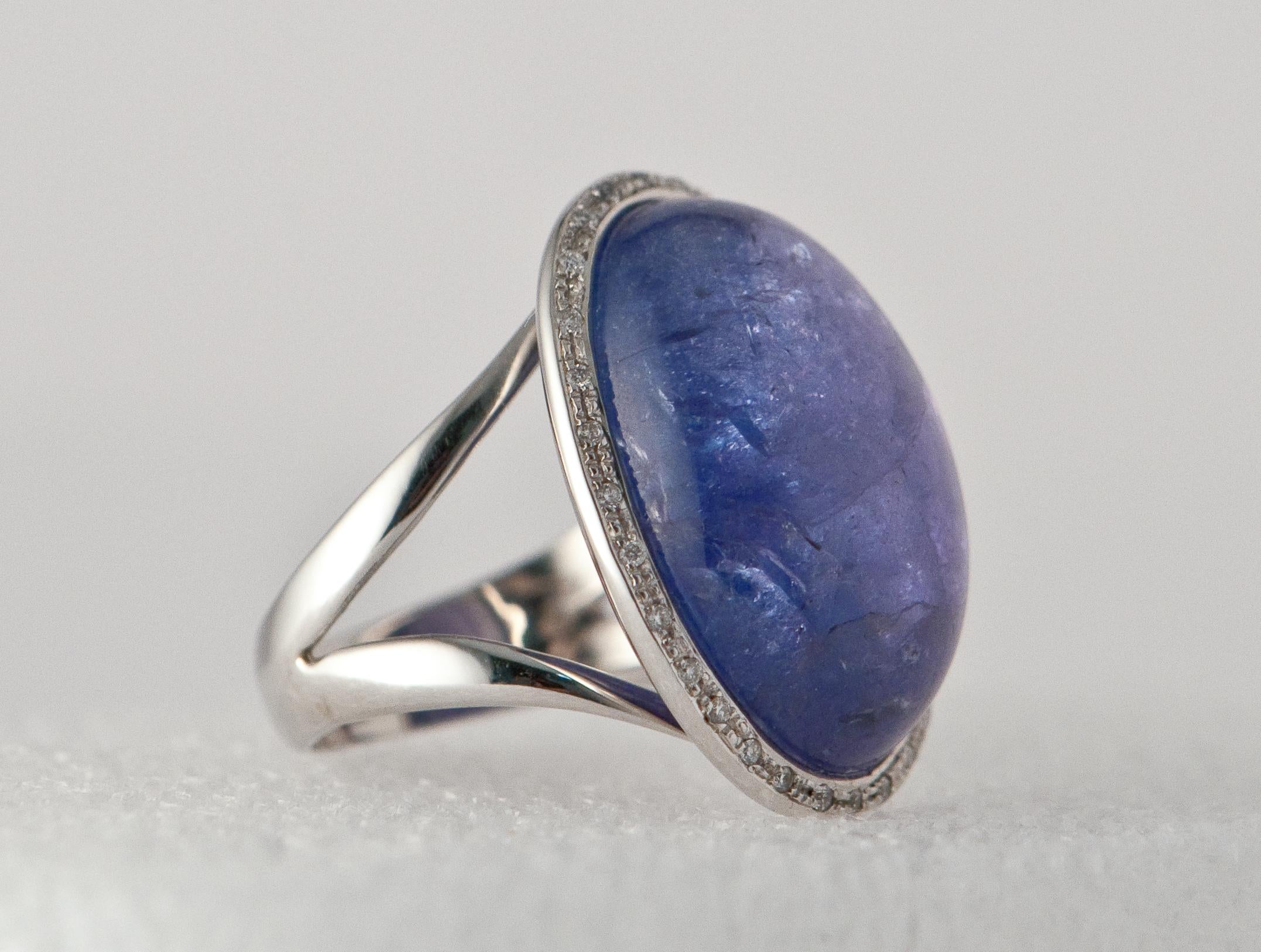 White Gold ring with tanzanite, round shape cabochon. 
Ornamented with diamonds 0.12 ct  
White gold 18 ct  
Size of gemme: 22 mm x 18 mm
US Size : 6,5 
French size 53