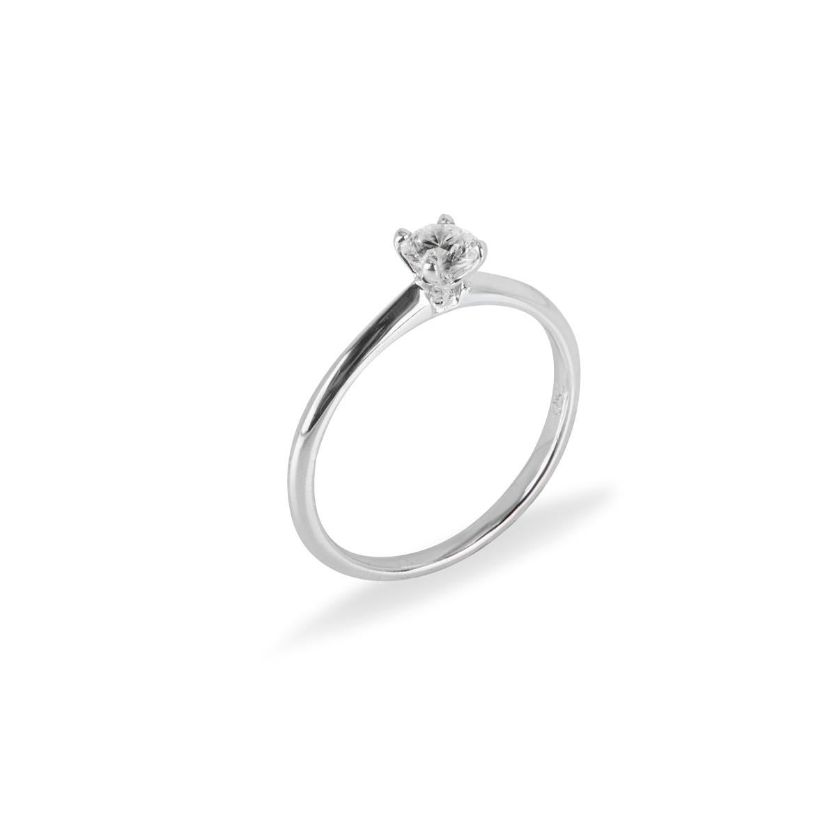 A classic 18k white gold diamond solitaire engagement ring. The solitaire features a round brilliant cut diamond in a four claw mount weighing 0.36ct, H colour and SI clarity. The ring is currently a size UK M½ - EU 52½ but can be adjusted for the