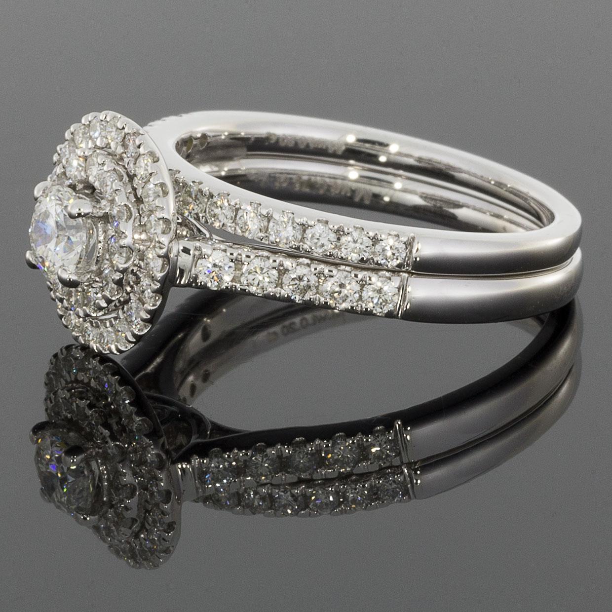 Item Details:
Estimated Retail - $3,550.00
Metal - White Gold
Total Carat Weight (TCW) - 0.96 ctw
Style - Double Halo Wedding Set
Ring Size - 6.50
Sizable - Yes
Metal Purity - 14k

Stone 1 Information:
Stone Type - Diamond
Stone Shape - Round