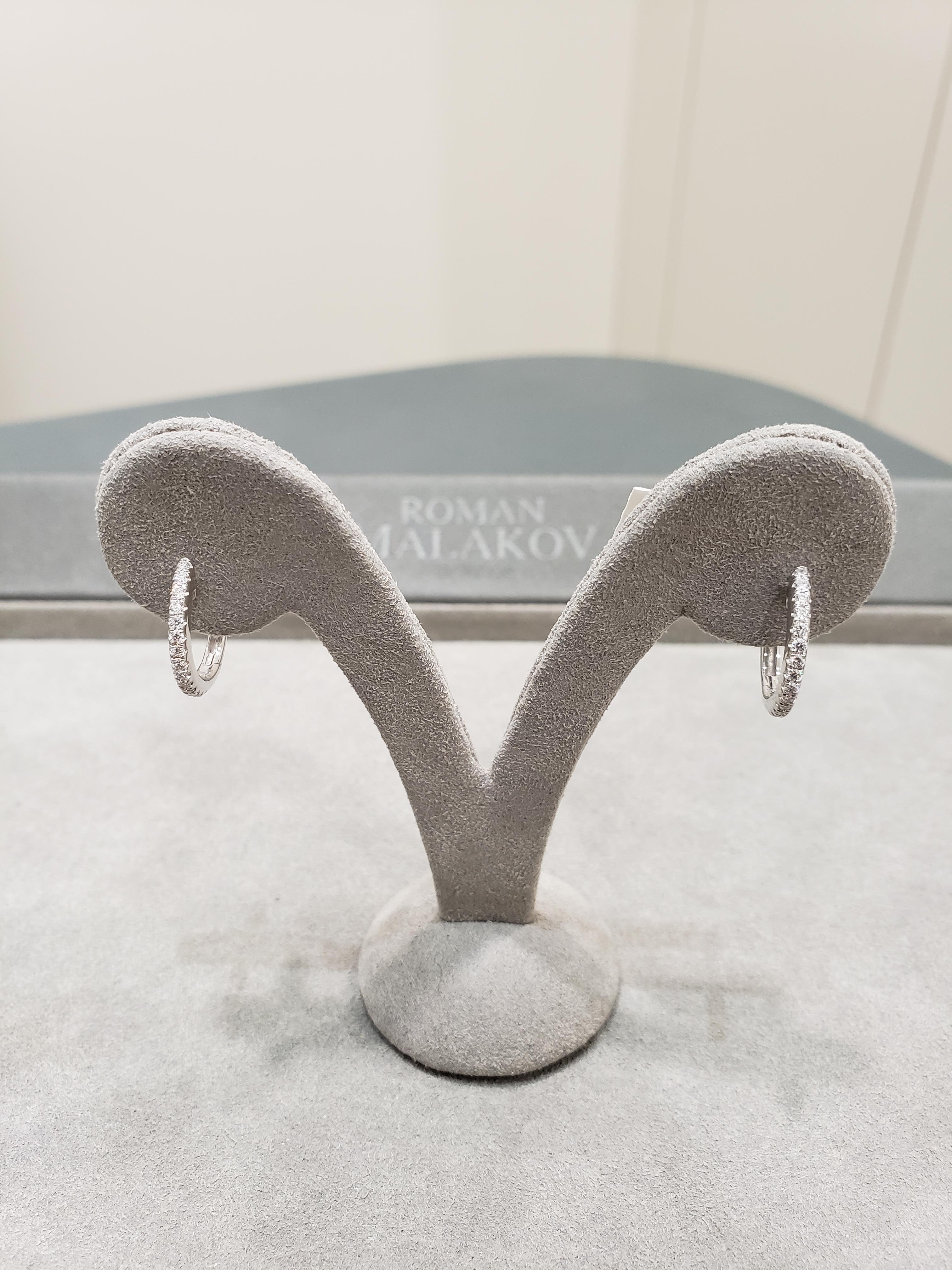 A simple pair of hoop earrings set with round brilliant diamonds in 14 karat white gold. Diamonds weigh 0.29 carats total.

Style available in different price ranges. Prices are based on your selection of the 4C’s (Carat, Color, Clarity, Cut).
