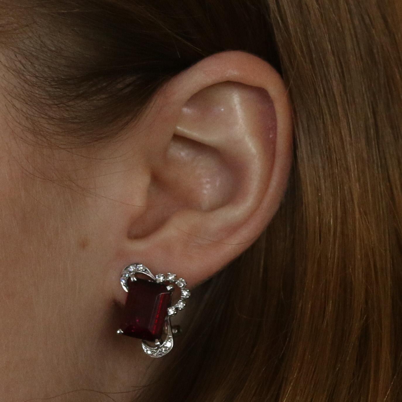 Era: Retro 1940s - 1950s

Metal Content: 18k White Gold

Stone Information: 
Genuine Rubellite Tourmalines
Carat(s): 8.24ctw
Cut: Emerald
Color: Slightly Purplish Red

Natural Diamonds
Carat(s): .34ctw
Cut: Single
Color: F - G
Clarity: VS1 -