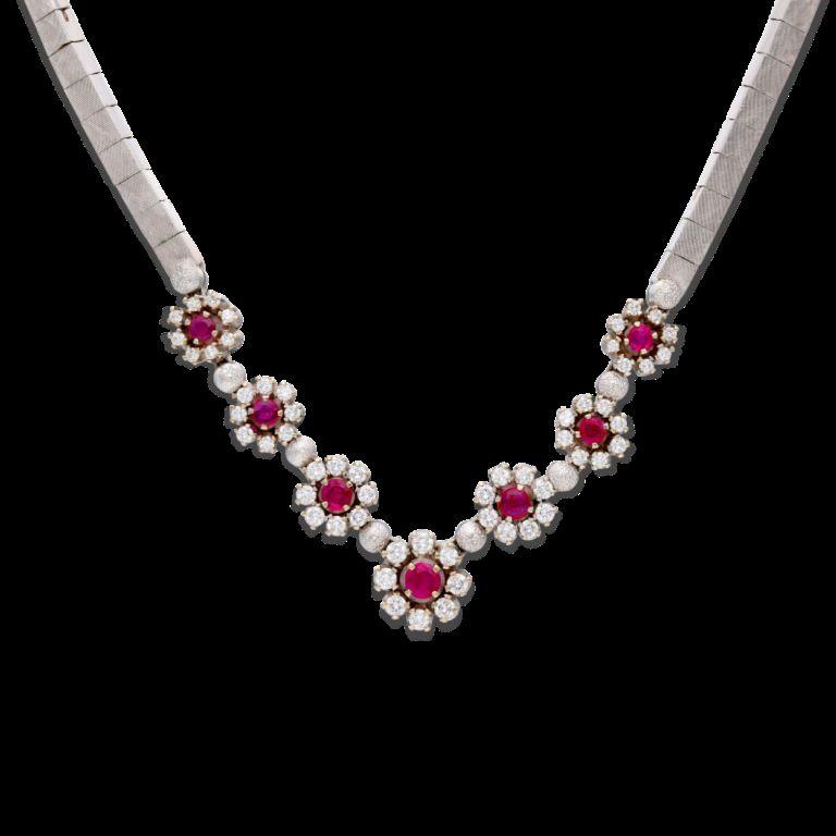 Featuring 7 round rubies, accented by 56 round brilliant cut diamonds. 
- Rubies weighing a total of approximately 1.40 carats 
- Diamonds weighing a total of approximately 2.20 carats
 - 18 karat white gold 
- Inner circumference 16 inches 
- Total