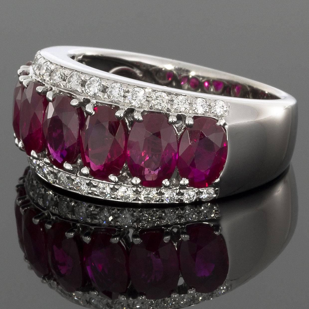 This beautiful 18K white gold ruby and diamond ring features 7 oval rubies and 30 round white accent diamonds that are prong set. The ring is a size 6.75 and GGL certified. Your new ring will surely impress anyone who sees it. MSRP
