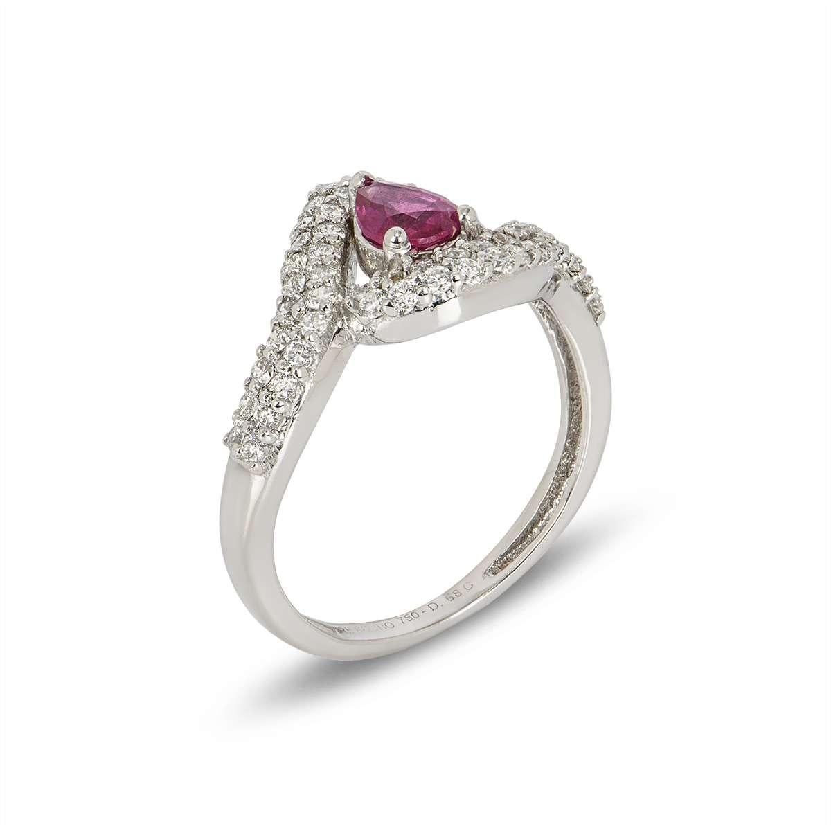 A beautiful 18k white gold ruby and diamond cluster dress ring. The ring is set to the centre with a 0.54ct pear shaped ruby in a 3 claw setting which disperses a deep red hue throughout. The ruby is complemented by a double row of pave set round