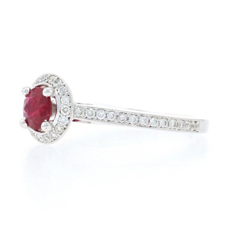 Let romance shine! Accented by ornate milgrain work and fashioned in a cathedral style, this gorgeous 14k white gold ring showcases a majestic ruby solitaire sweetly embraced by a sparkling diamond halo that is accompanied by radiant diamonds set