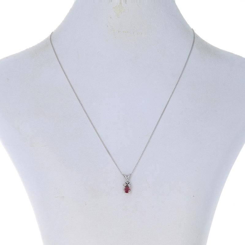 Metal Content: 14k White Gold

Stone Information
Natural Ruby
Treatment: Heating
Carat(s): .60ct
Cut: Round
Color: Pinkish Red

Natural Diamonds
Carat(s): .12ctw
Cut: Round Brilliant
Color: G - H
Clarity: SI2 - I1

Total Carats: .72ctw

Chain Style: