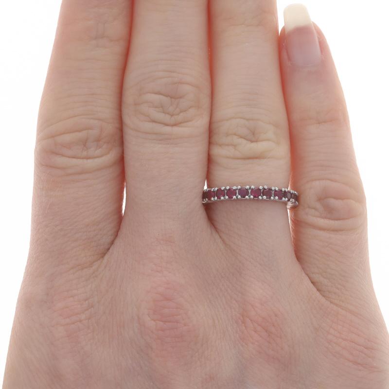Size: 5

Metal Content: 18k White Gold

Stone Information
Natural Rubies
Treatment: Heating
Carat(s): 1.50ctw
Cut: Round
Color: Pinkish Red

Total Carats: 1.50ctw

Style: Eternity Band
Features: Stackable Design

Measurements
Face Height (north to