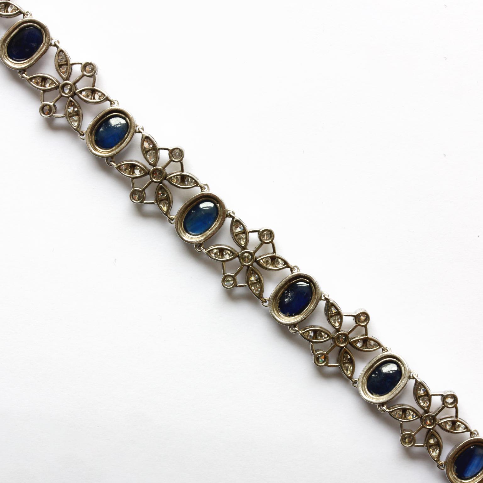 A white gold bracelet with 11 cabochon cut sapphires  (app. 15 carat in total) alternated with a little flower with four navette shaped leaves, each leaf set with a brilliant cut diamonds (app. 2.5 carat  in total), circa 1950.

length: 19.5